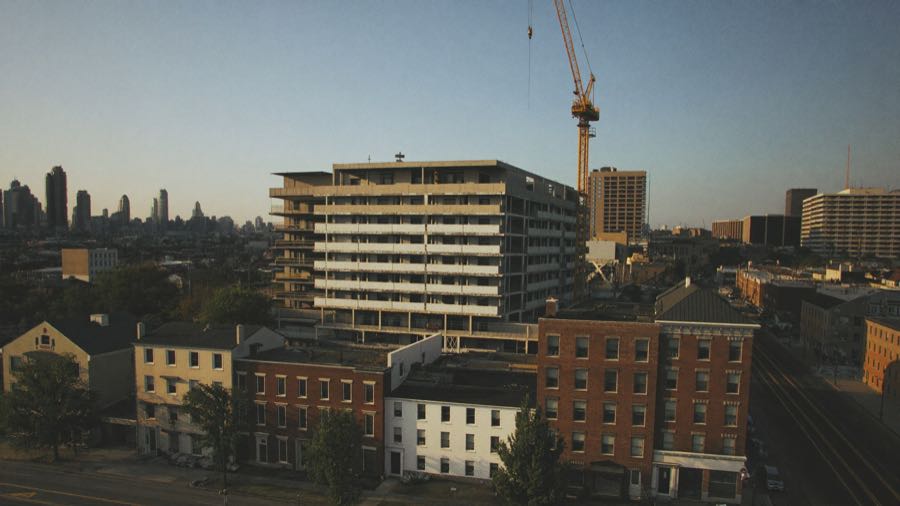 Aerial view of a residential development under construction in a Chicago neighborhood at golden hour, TERAMOK developer marketing