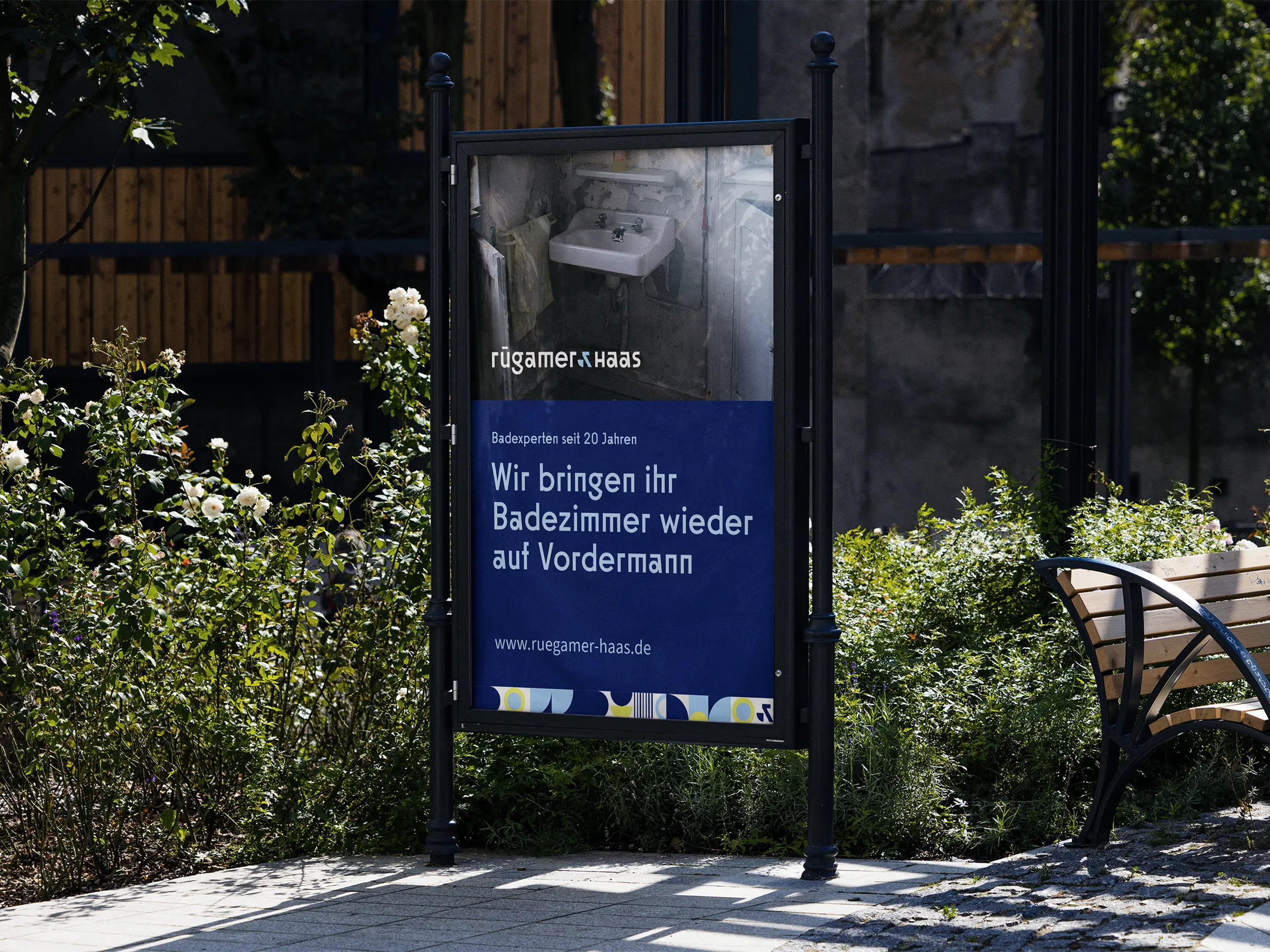 Werbesäule von Rügamer & Haas mit Schwarz-Weiß-Foto eines alten Bads und Headline „Wir bringen ihr Badezimmer wieder auf Vordermann“.