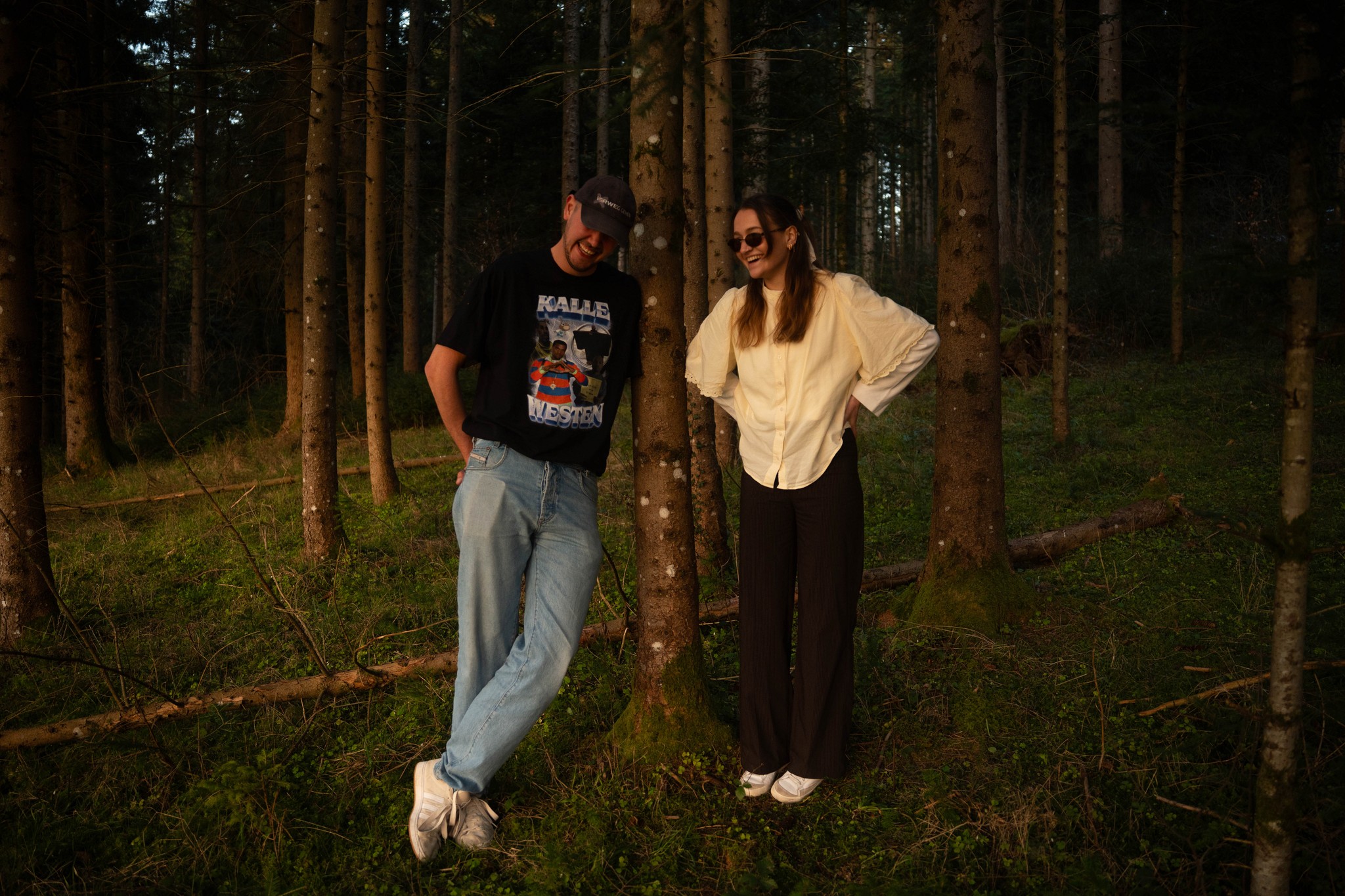 Three people sitting on a couch in a room looking at mobile devices