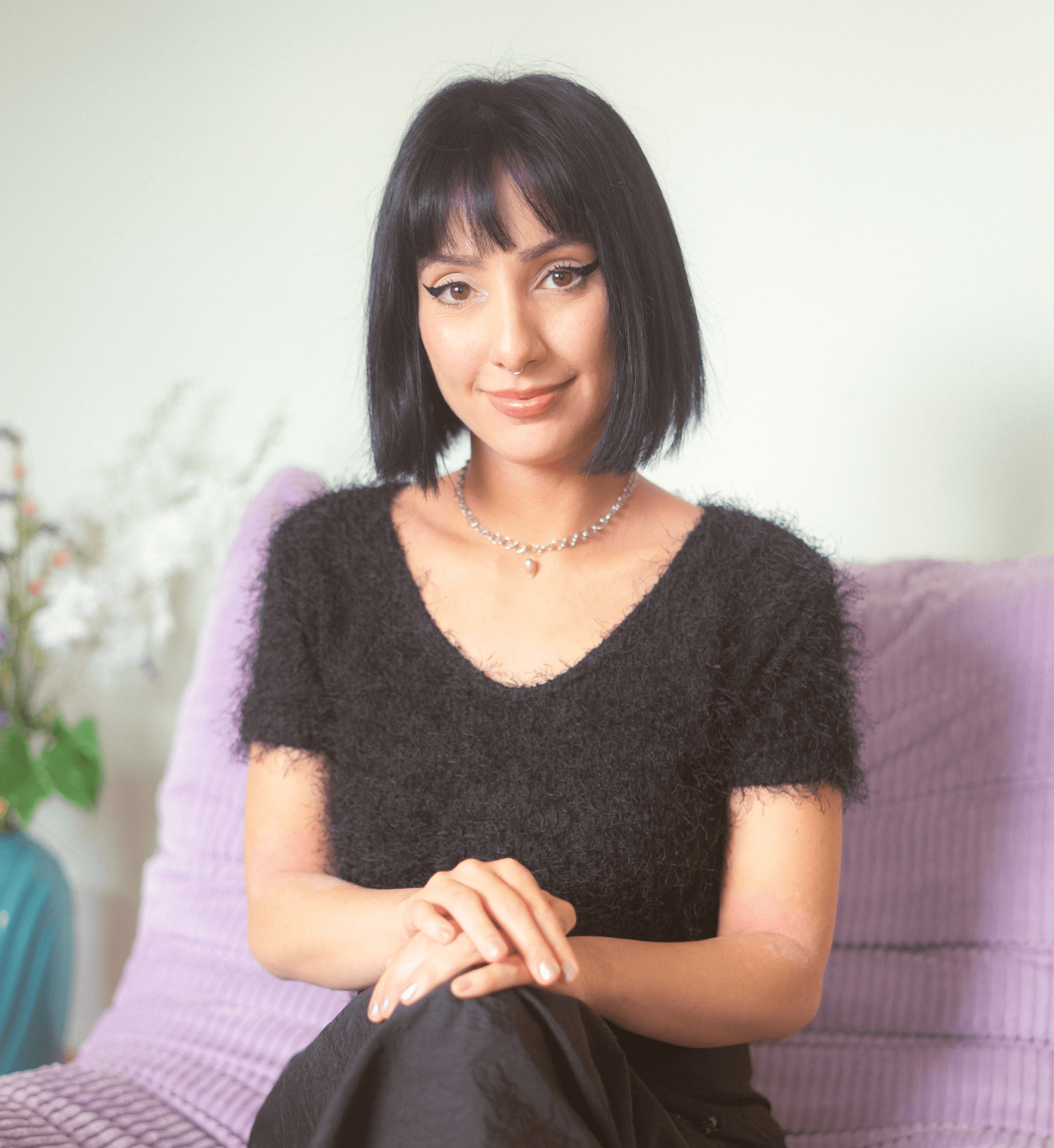 Visual designer headshot in a minimalist studio 