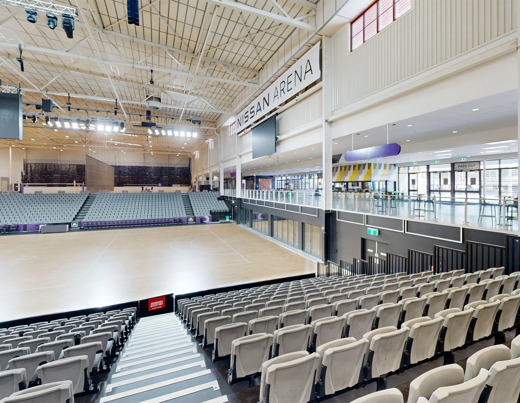 The show court and tiered seating at Nissan Arena in Brisbane, captured by ABM visual for Cérge's accessibility platform.