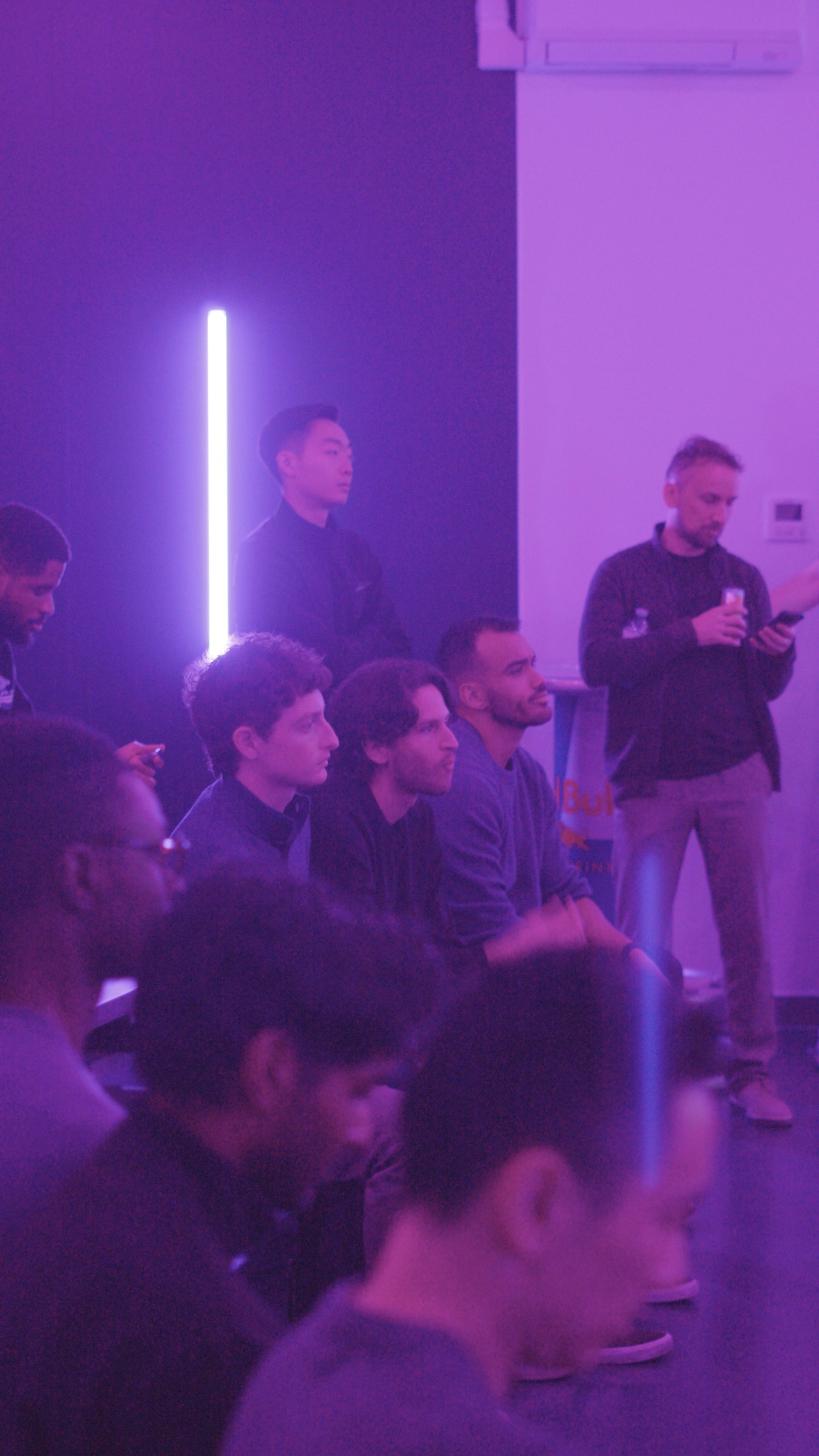 a group of people standing in a dark room