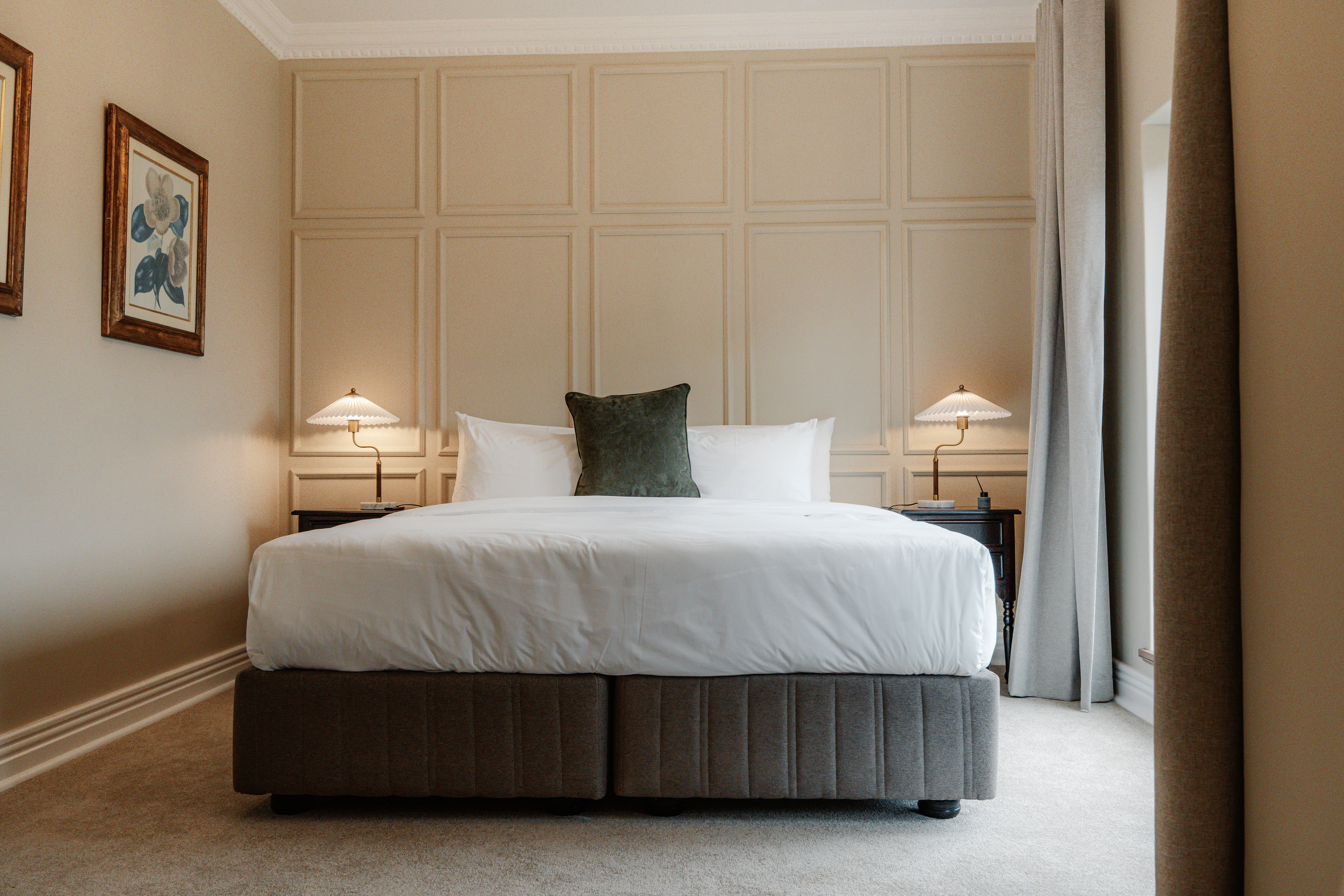 Elegant bedroom in Executive Suite with king-size bed and estate views.