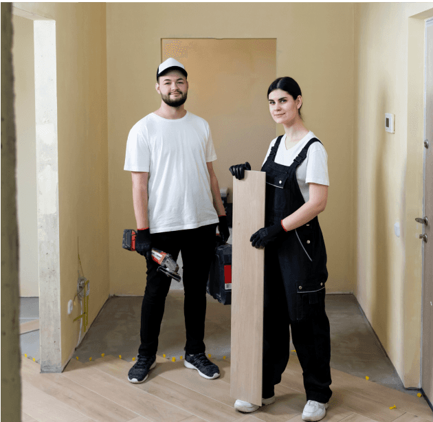 Team of two workers preparing a room for renovation.