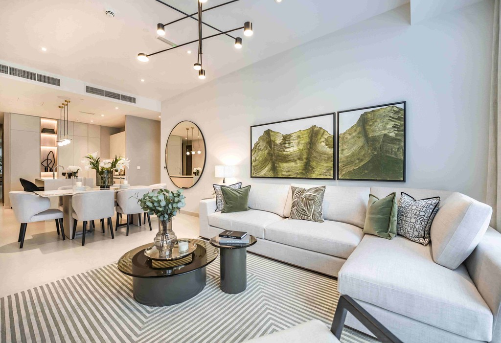 A modern living room featuring a large mirror, showcasing contemporary design elements at Liv Lux, Dubai.