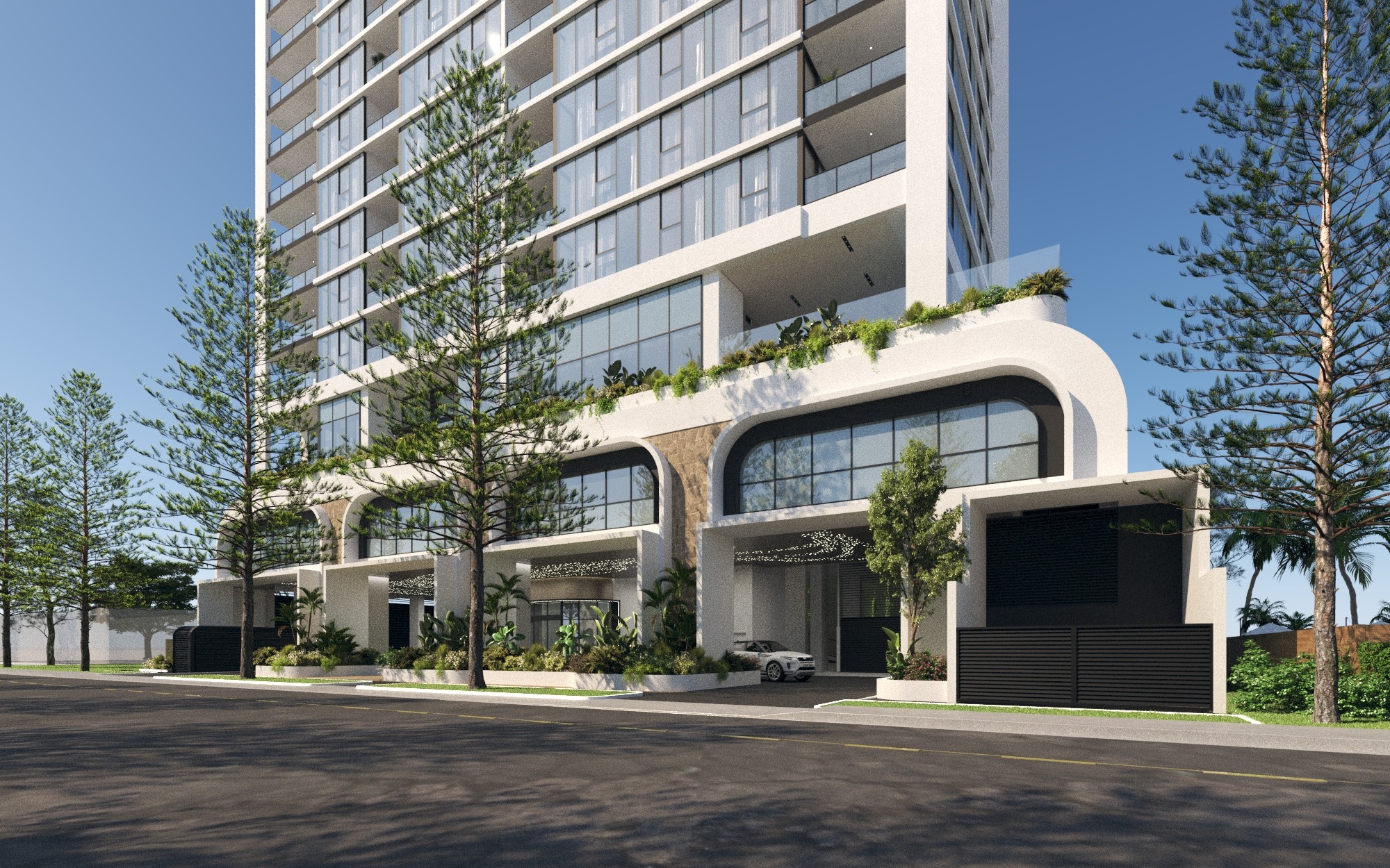 Street-Level Exterior: Street-level perspective of The Sterling showing its elegant curved architecture, landscaped entry and grand arrival experience framed by coastal pines.