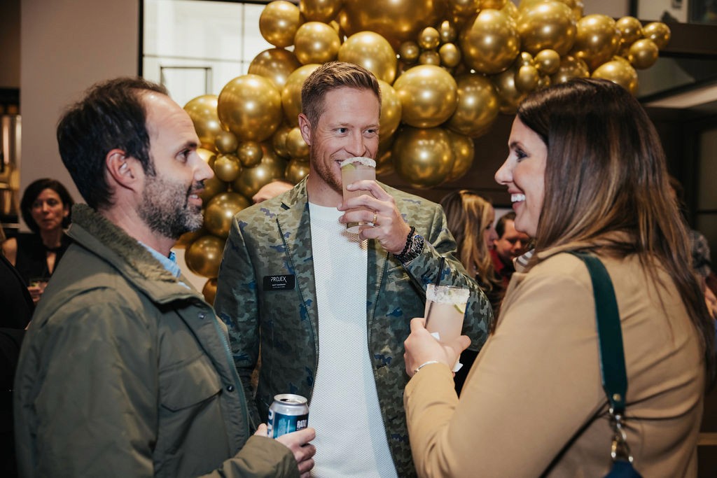 Man sipping a cocktail at an event