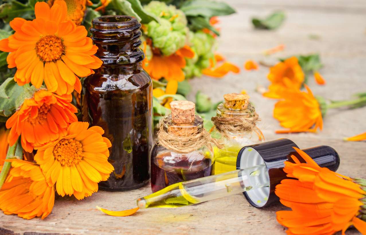 woman sitting in front of black table writing on white book near window
