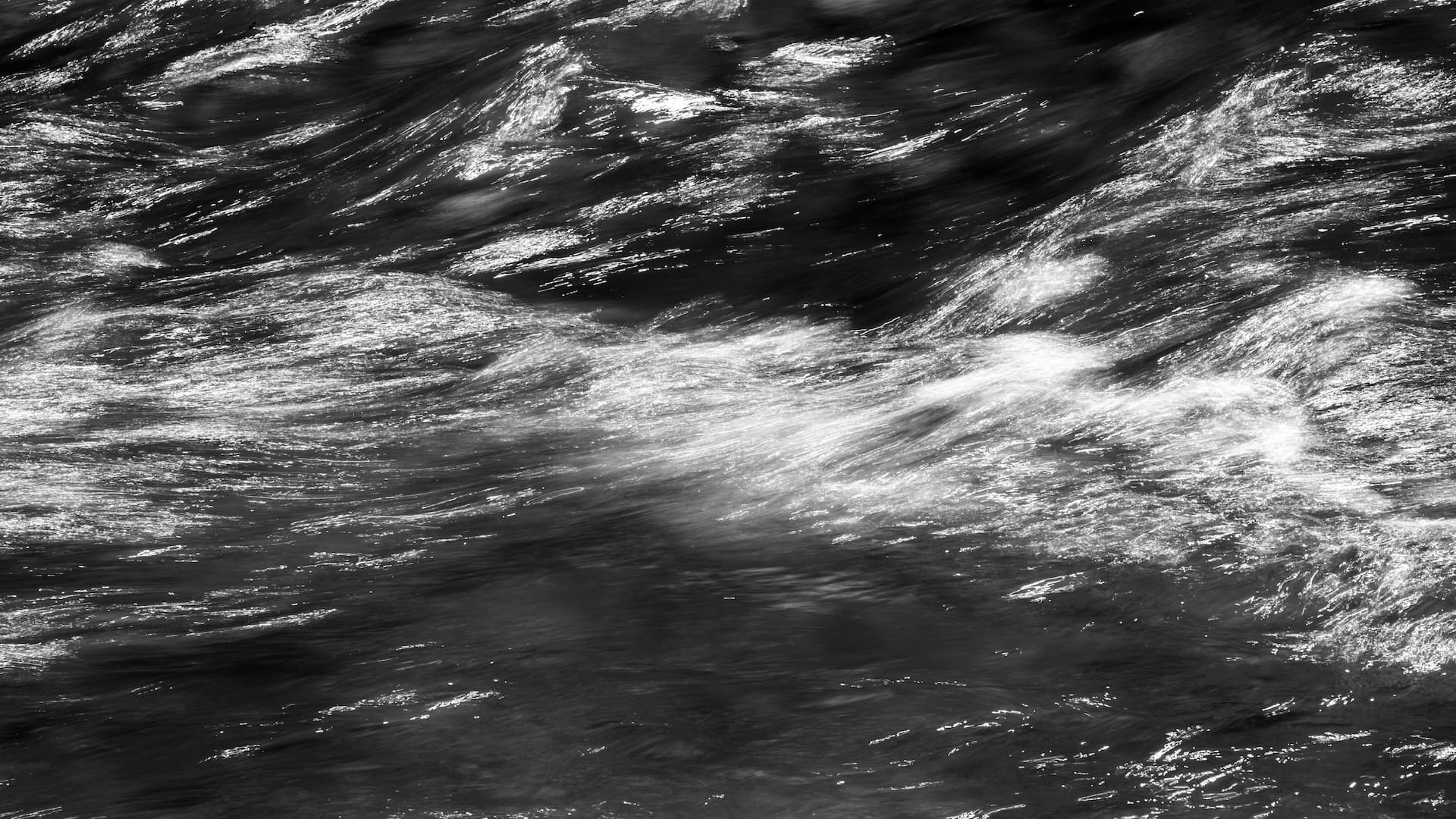 a black and white photo of a river
