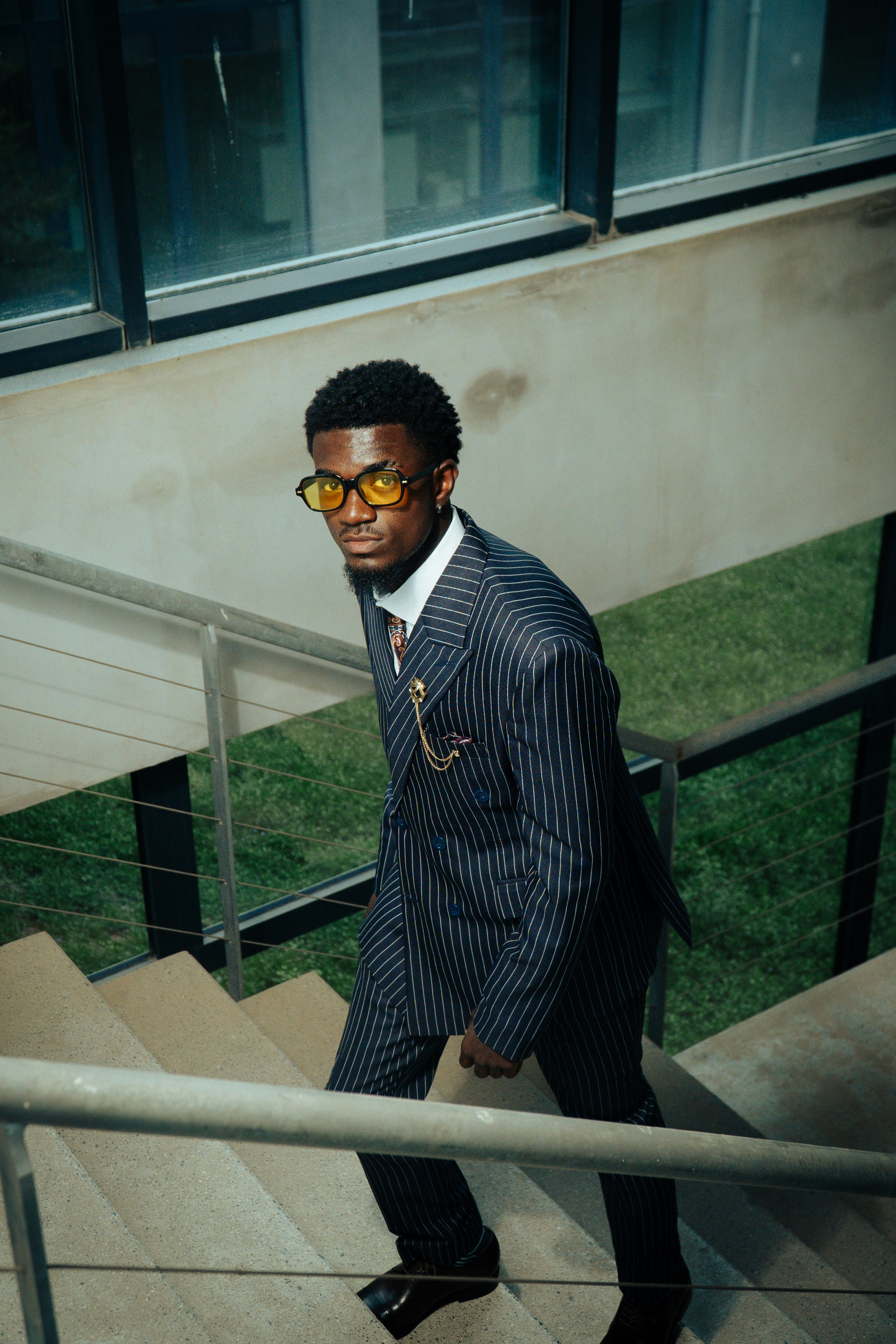 Man in suit ascending staircase.