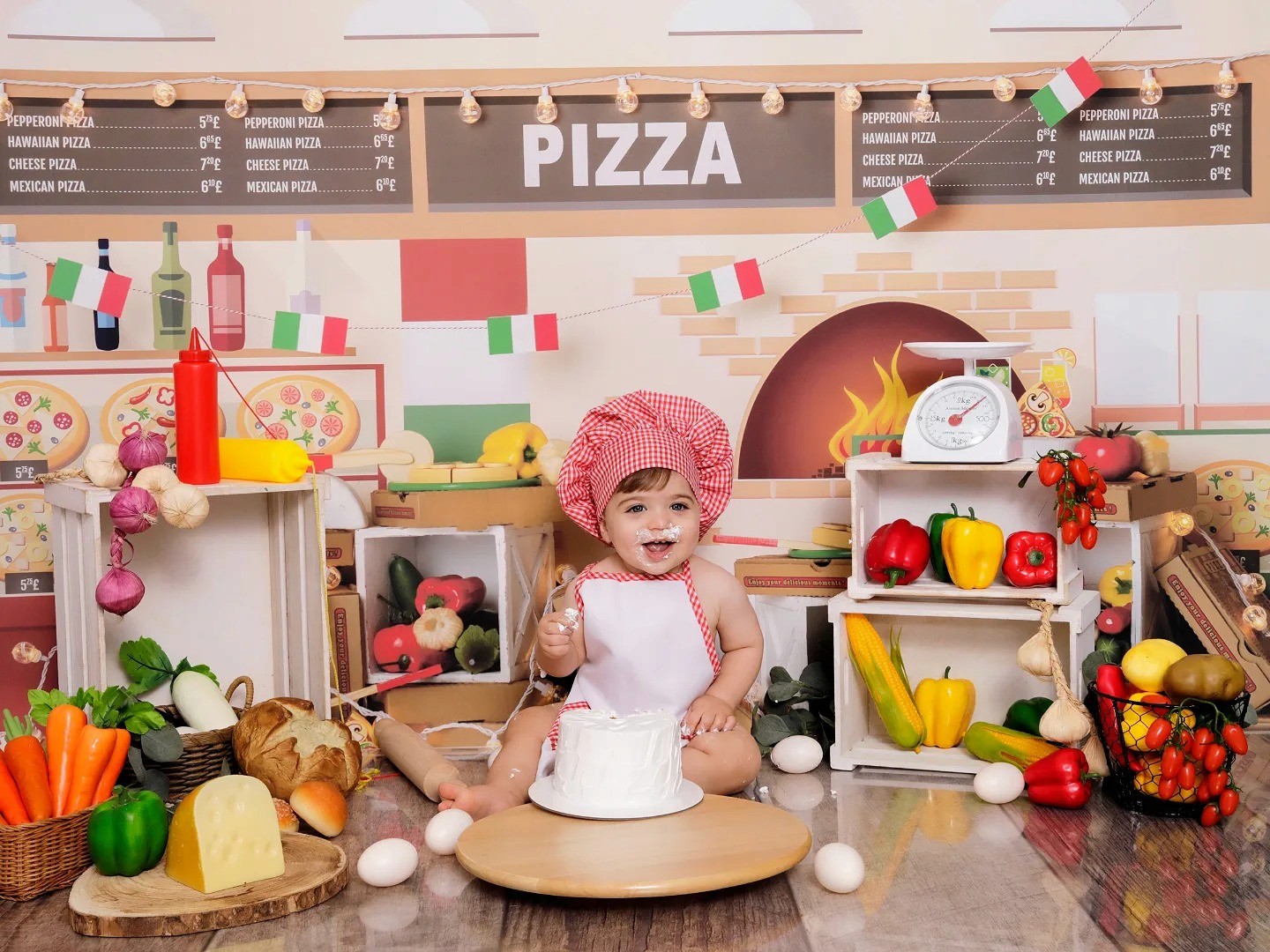A baby celebrating a birthday with a pizza theme