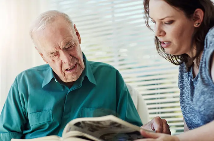 Caregiver in conversation with a senior client during a daily companionship visit