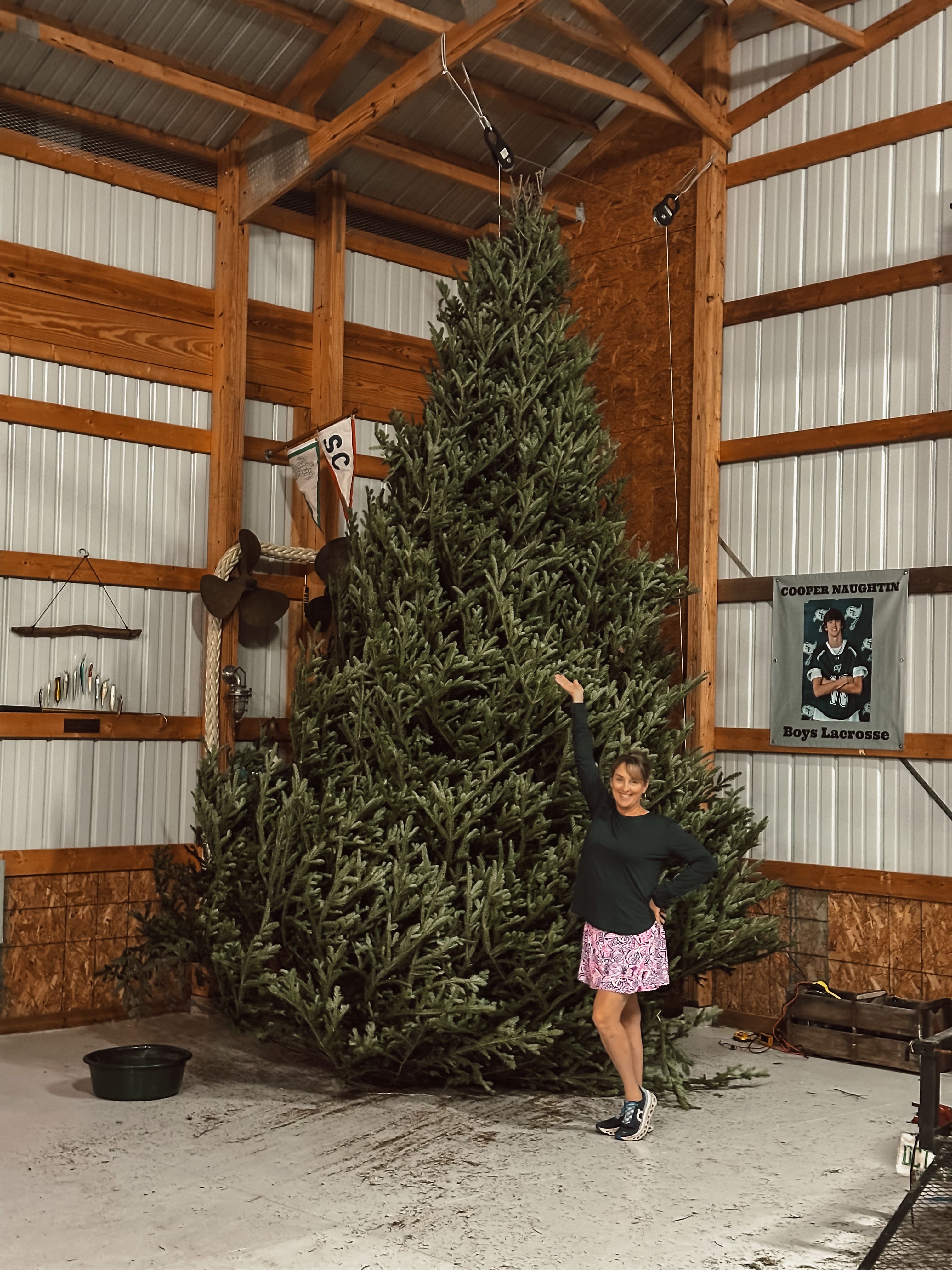 hodge podge customer standing happily in front of their christmas tree