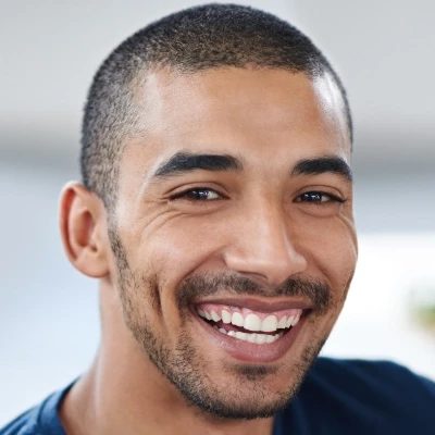 Ethnic man smiling at camera.