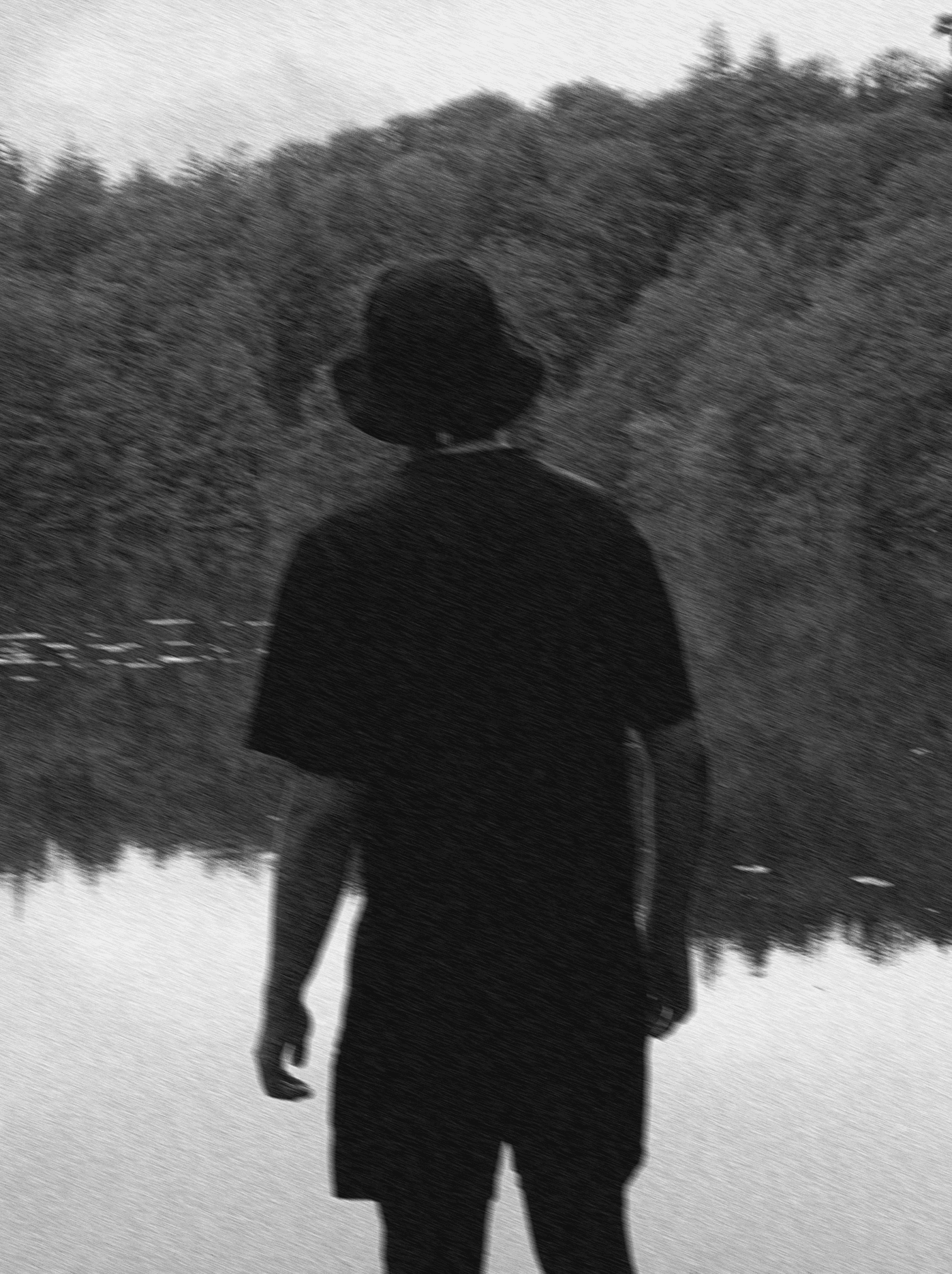 a blurry photo of a person standing in front of a wall