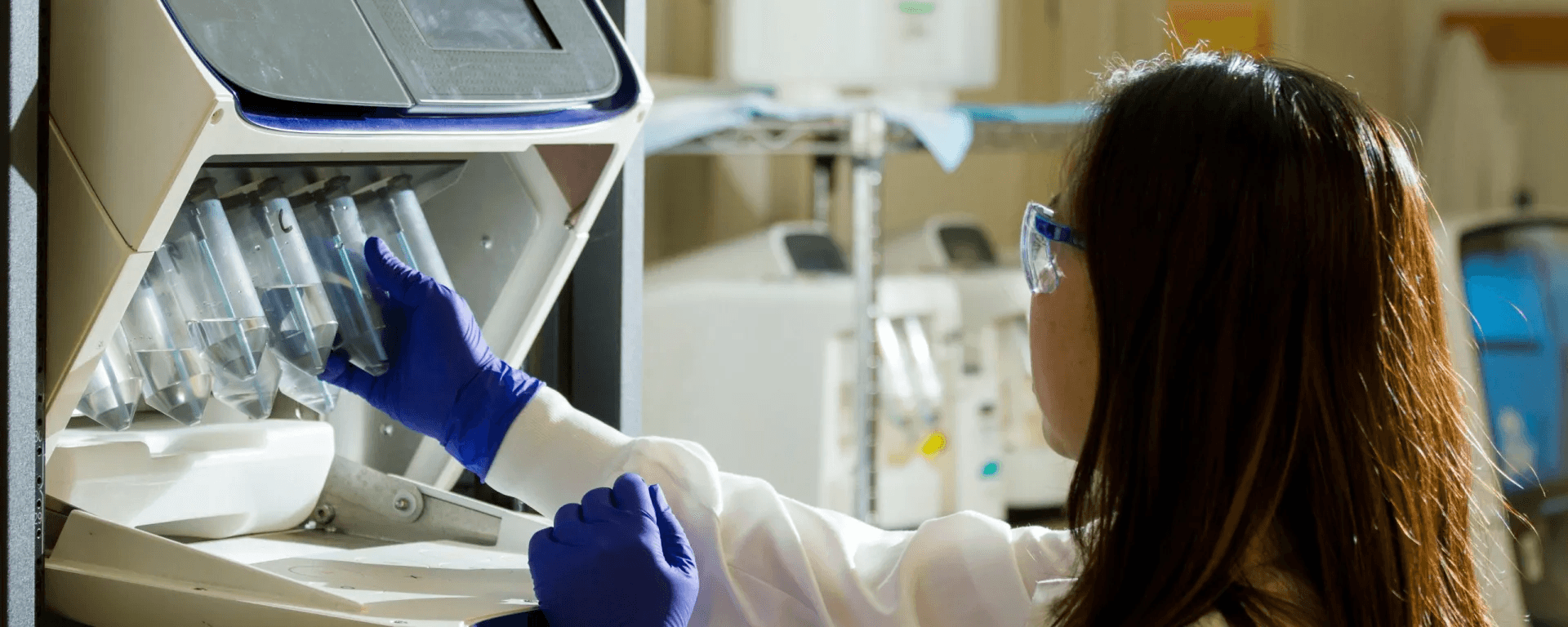 High school student working on biomedical engineering research with a PhD mentor in a university laboratory setting