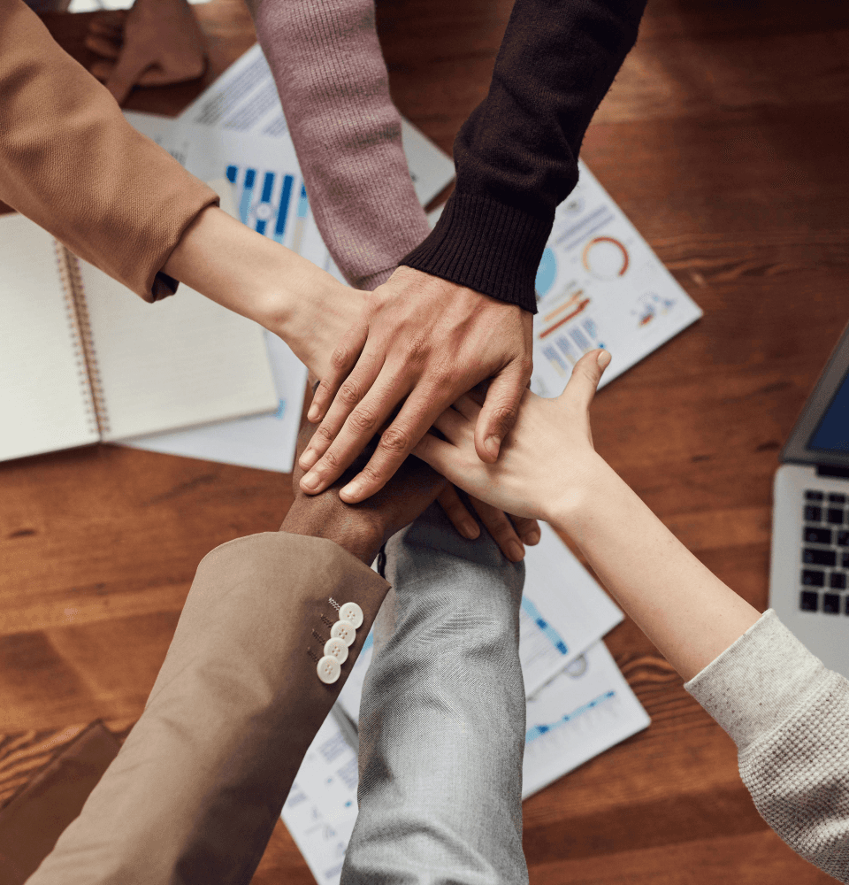 Team joining hands together