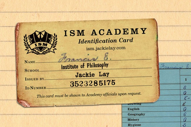 A yellow identification card from the ISM Academy, issued to Jackie Lay, displays the name "Francis G. School of Philosophy," an ID number "3523285175," and the website "ism.jackielay.com." The card rests on lined paper, with a portion of a blue form visible to the right.