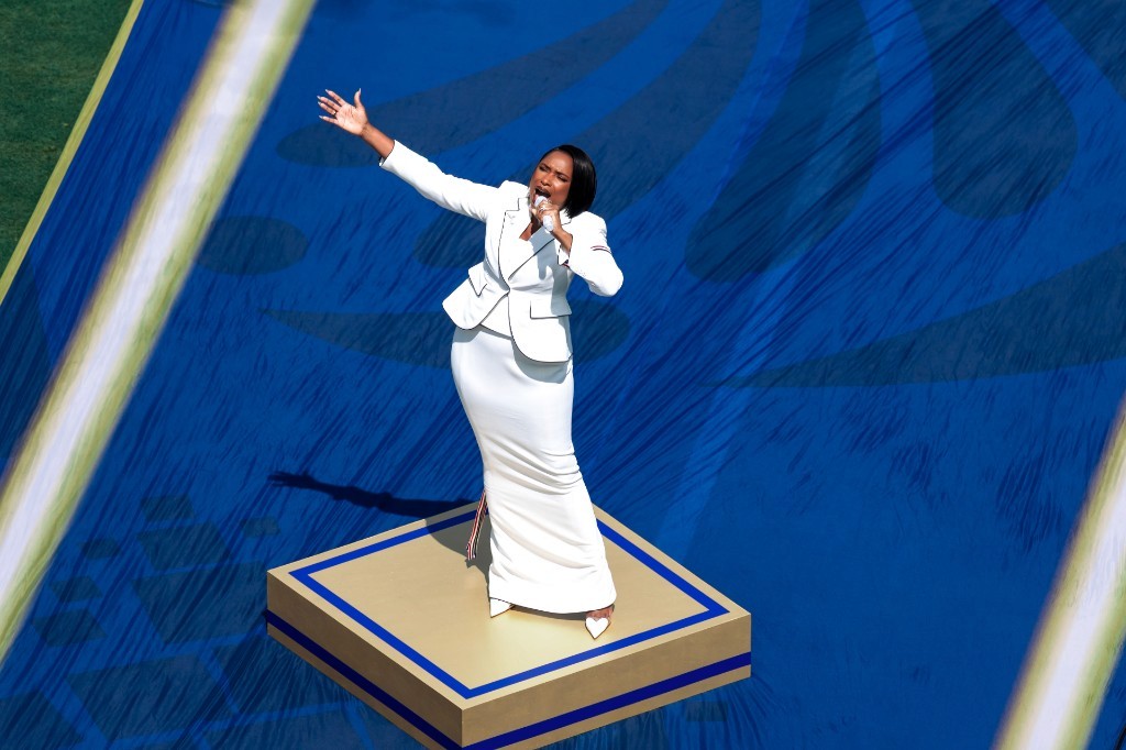 A performer sings on a blue World Cup stage before the Spain vs Argentina final at New York New Jersey Stadium