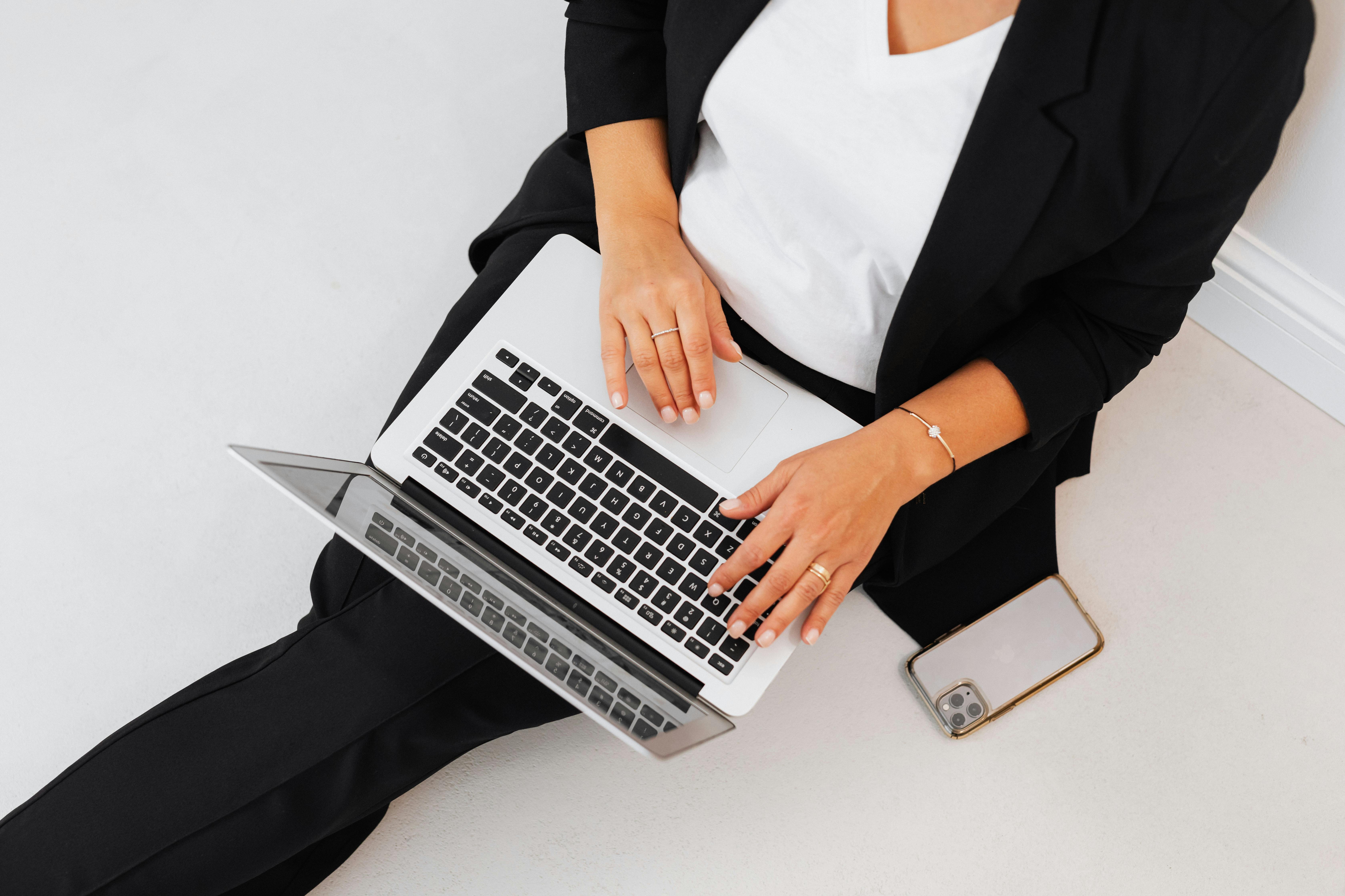 Woman in black blazer on laptop