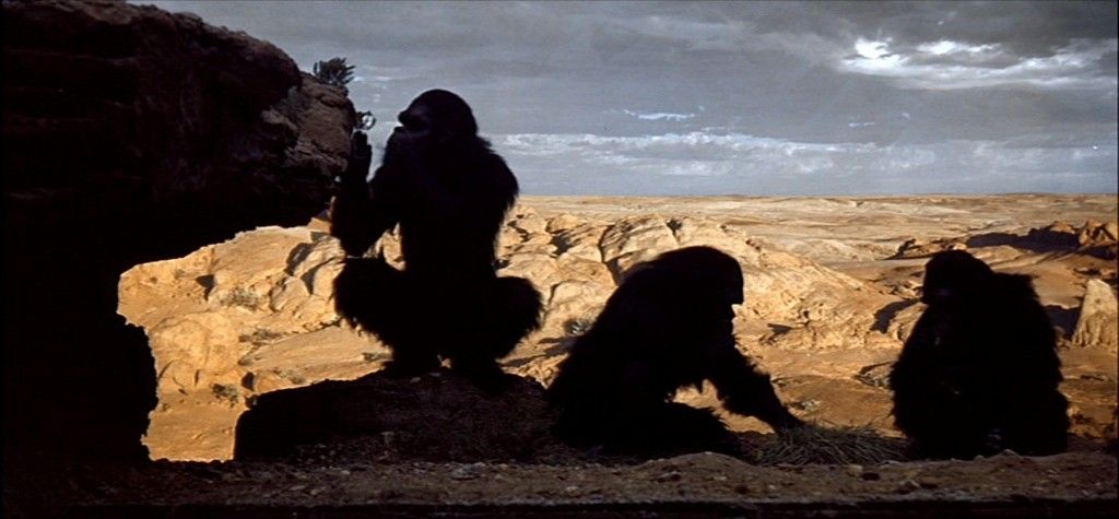 A person walks down a dimly lit alley at night.