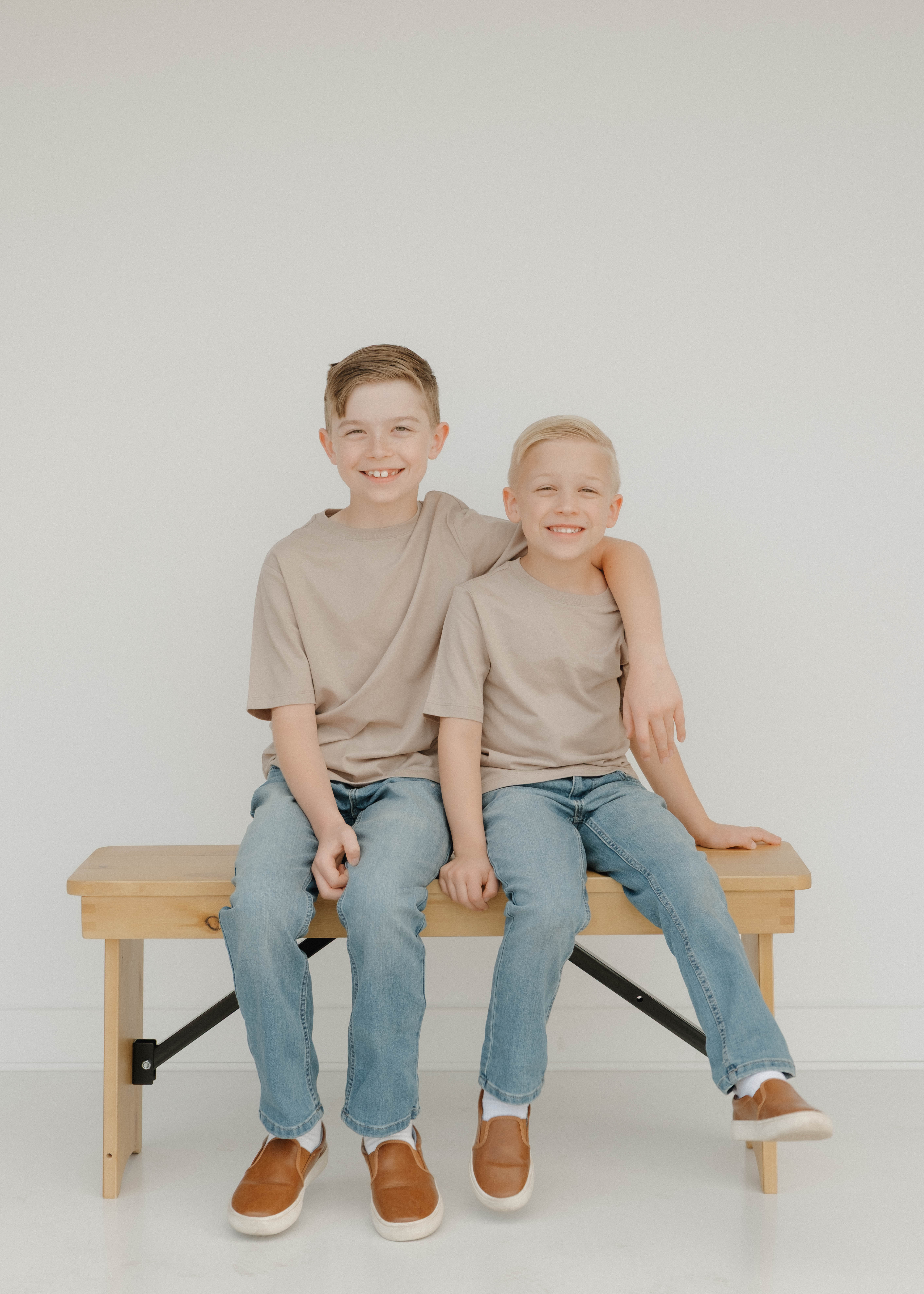 Golden hour couples photoshoot capturing a tender moment between a woman with long dark hair and a man with glasses and a beard.