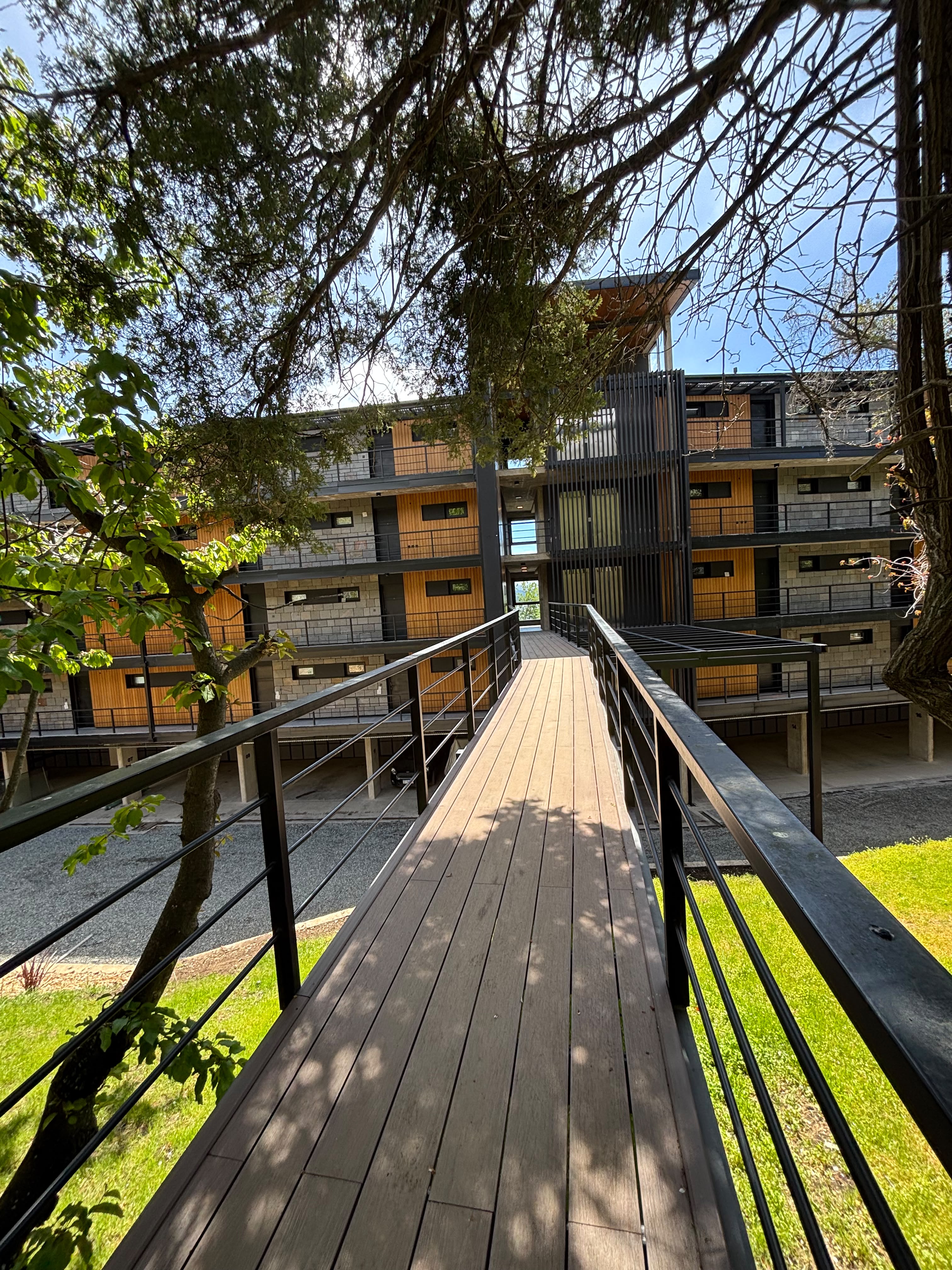 bench and dining table near body of water under calm sky