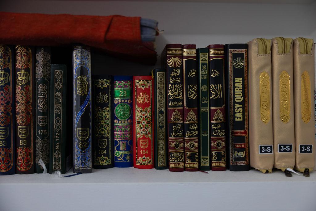 Three children jumping in burlap sacks during a race.