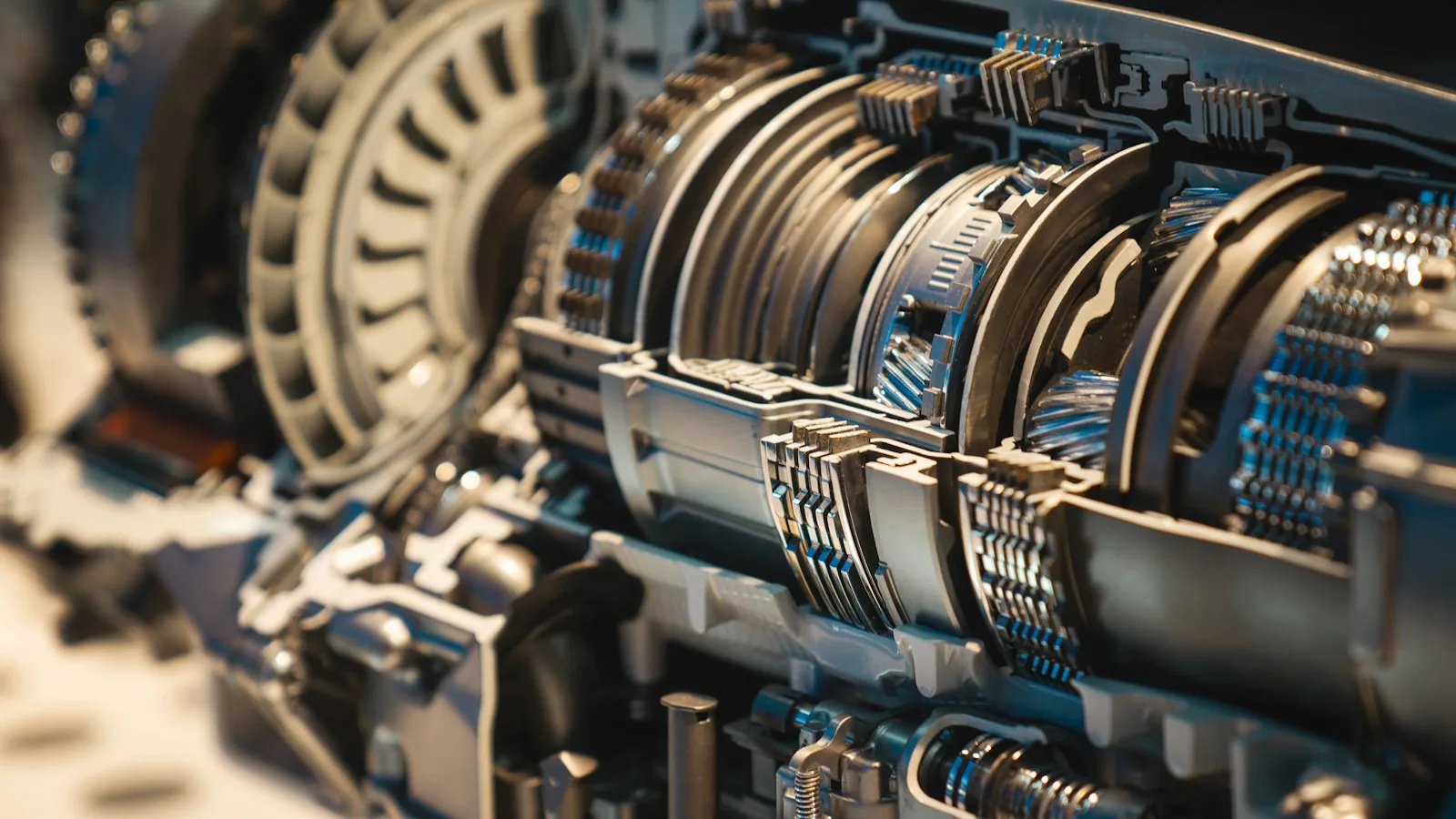Close-up of interlocking gears next to a glowing circuit-like network, representing automated workflow versus adaptive AI decision-making