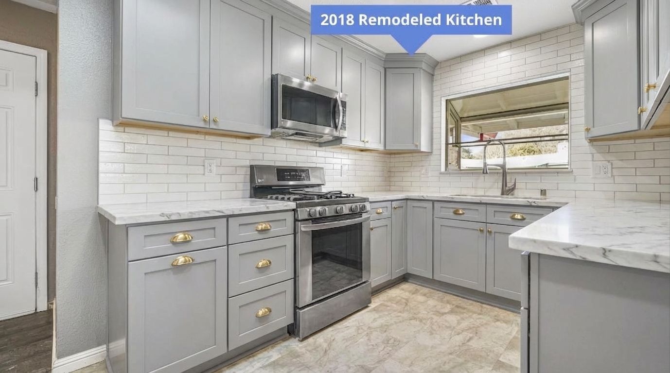 Kitchen with dove gray cabinets and gold hardware designed by AI