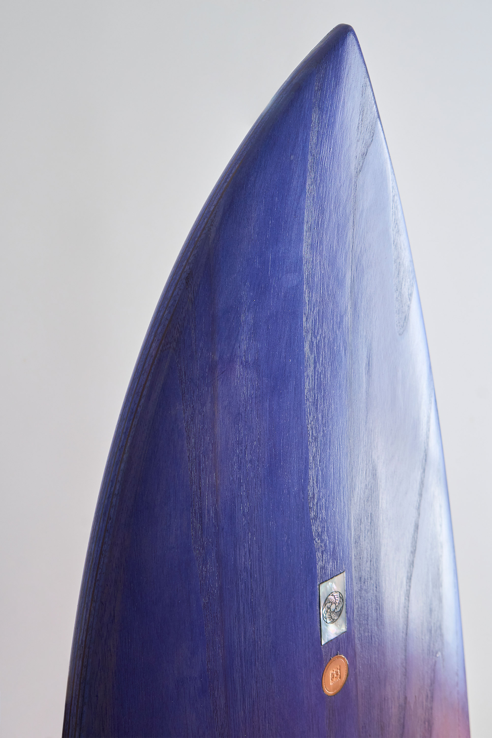 Purple stained timber surfboard nose