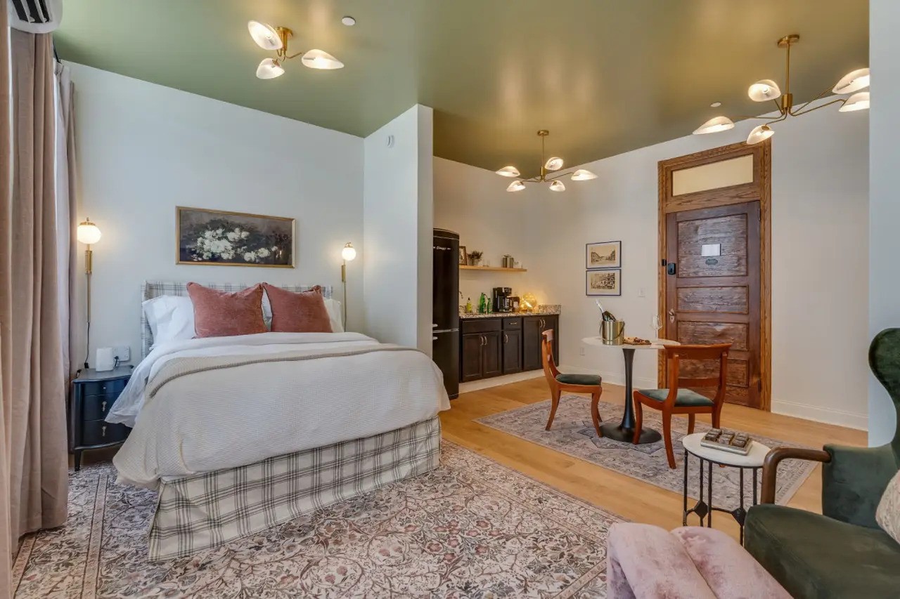 The Downtown Post hotel room bedroom and dining area