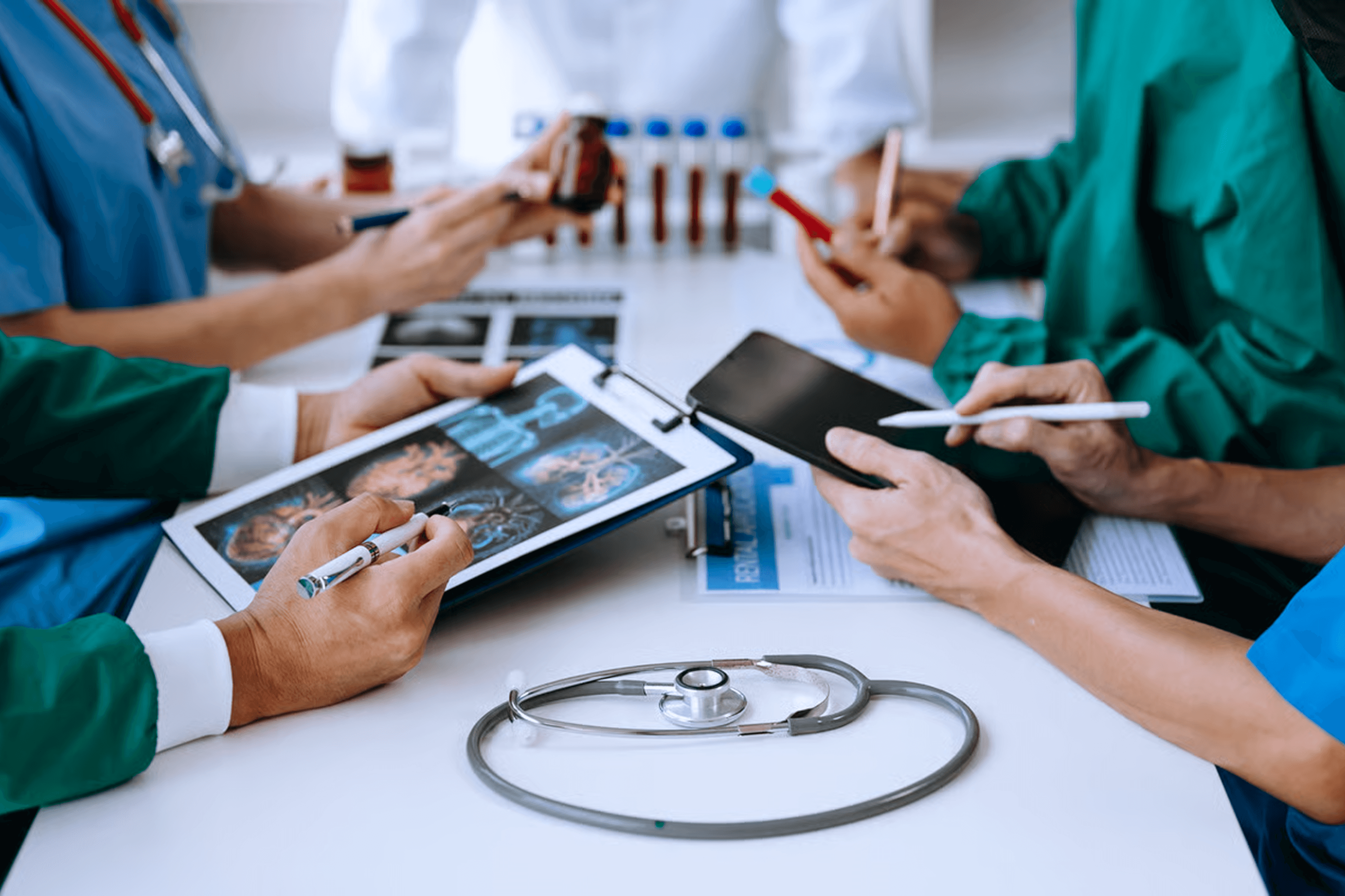 Clinicians reviewing patient scans and lab results on tablets, illustrating healthcare app development scope, timelines, and US budget planning (2026)