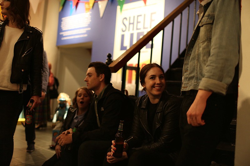 a woman smiling with a beer