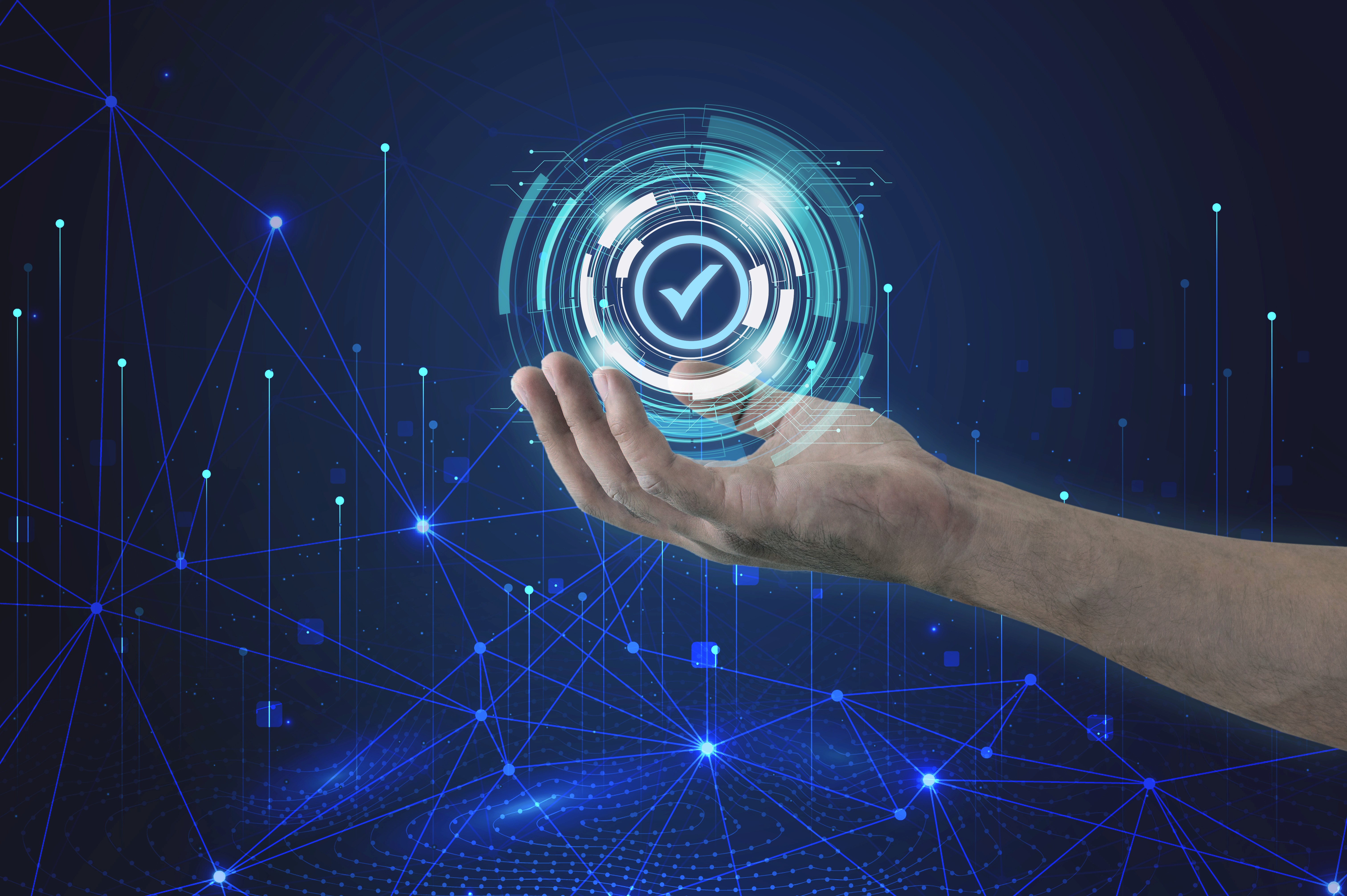 Hand holding digital checkmark hologram symbolizing Zero Trust security.MEs Can Build Psychologically Safe and Productive Team Cultures