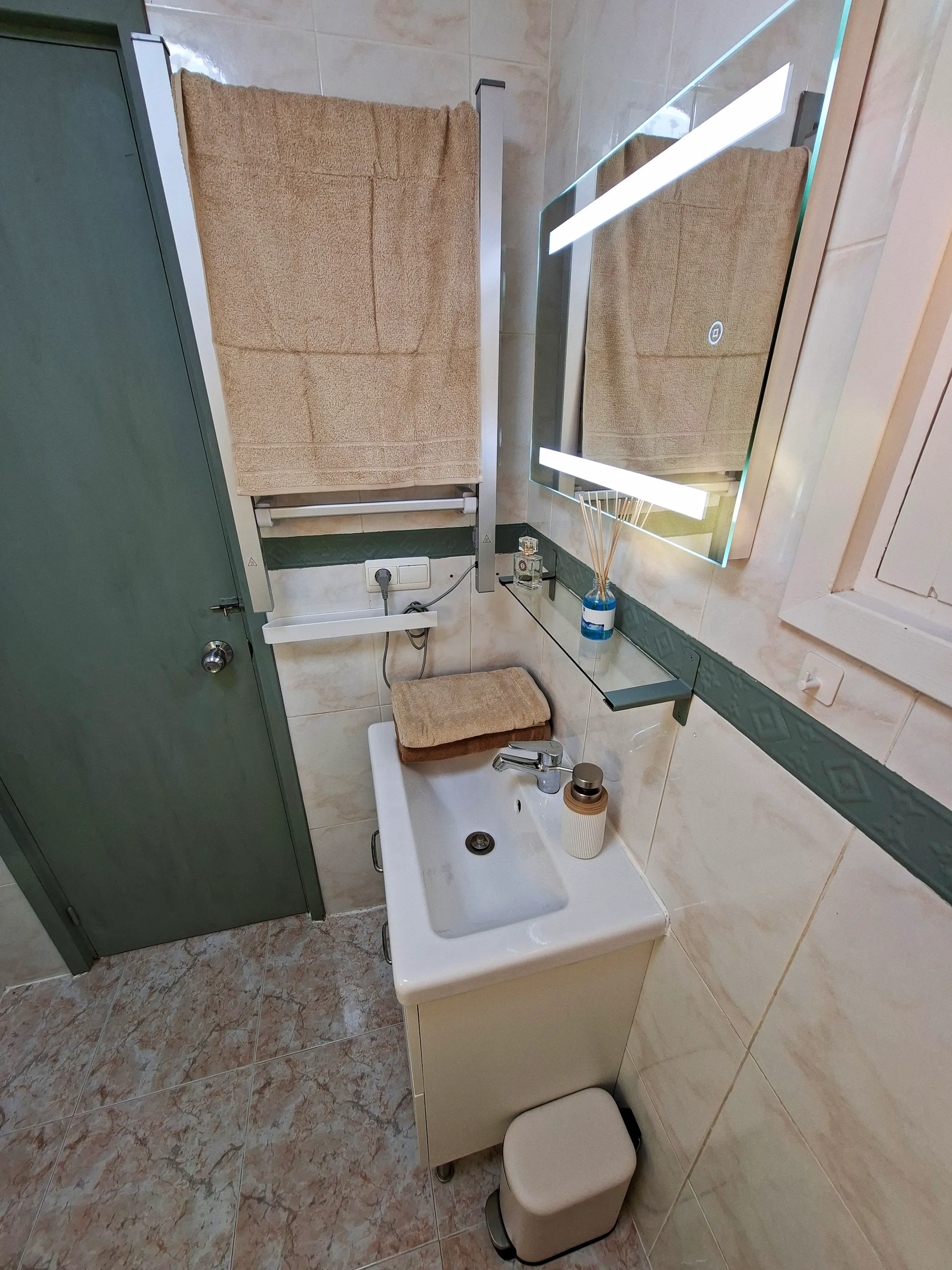 Minimalist living space with low modern furniture, large floor-to-ceiling windows, soft natural light, and an open view of a calm outdoor landscape.