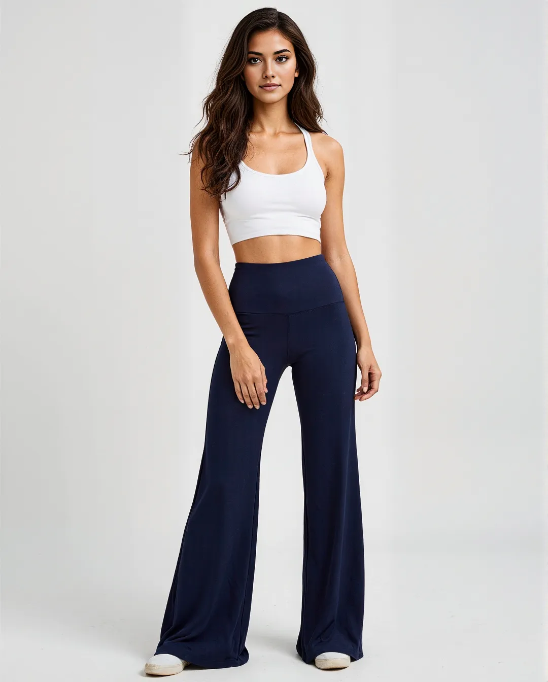 Professional fashion photograph showing white crop top and navy flare pants against clean white background, achievable with AI
