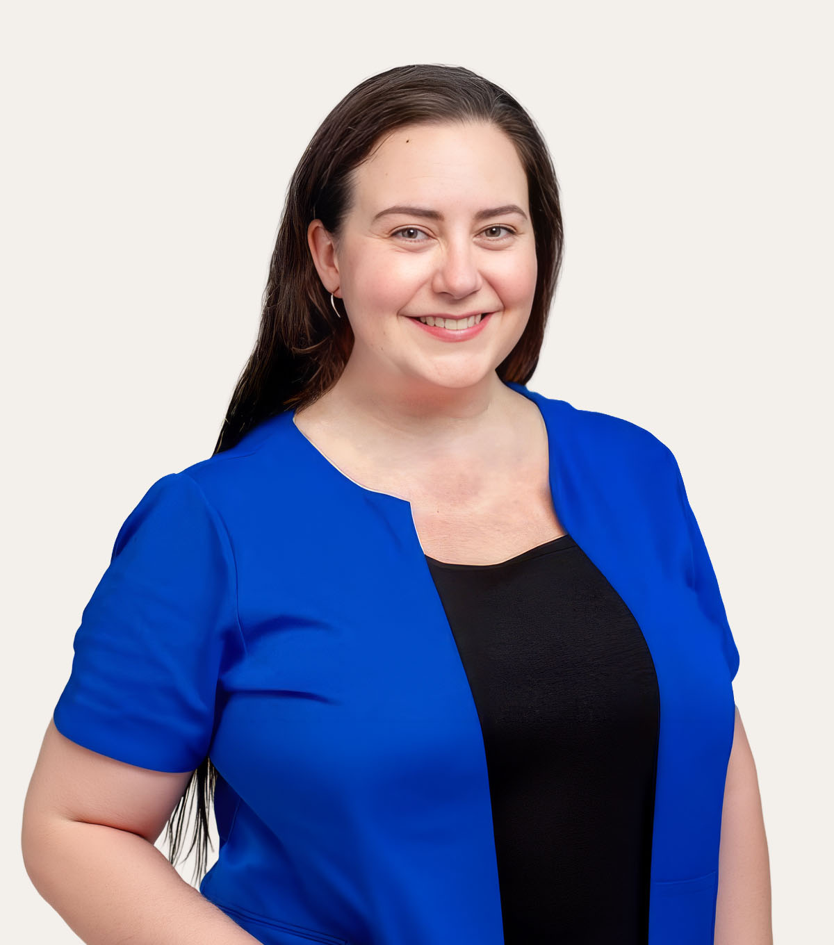 Woman with long brown hair wearing a blue blazer and black shirt smiling at the camera.