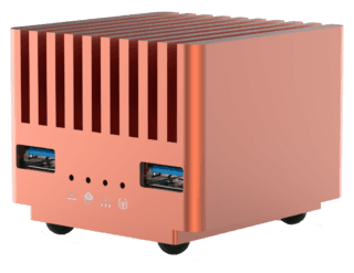 Small copper cube computer with USB ports and fins.