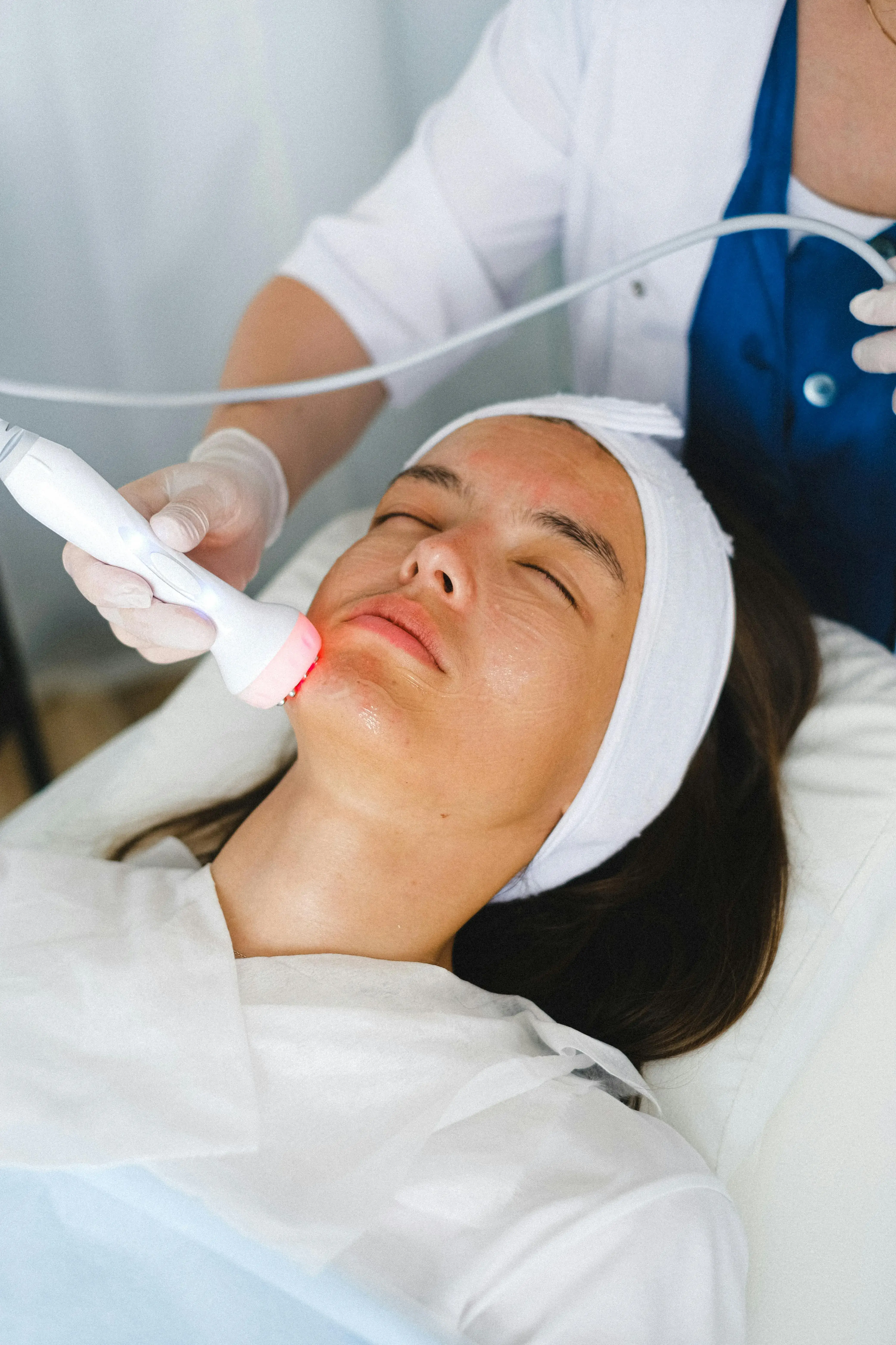 Client receiving HIFU facial treatment, a non-surgical ultrasound procedure designed to lift, firm, and smooth the skin for a youthful appearance.