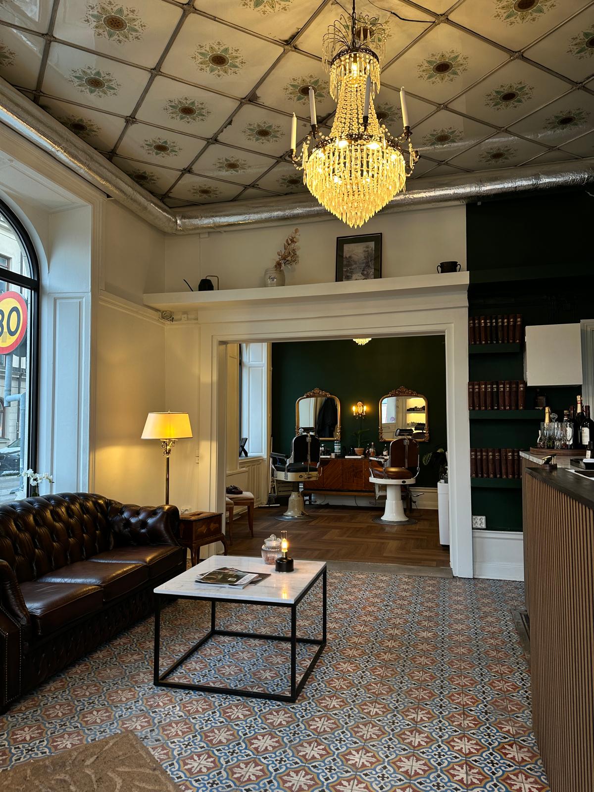 Barber styling a red-bearded man's hair