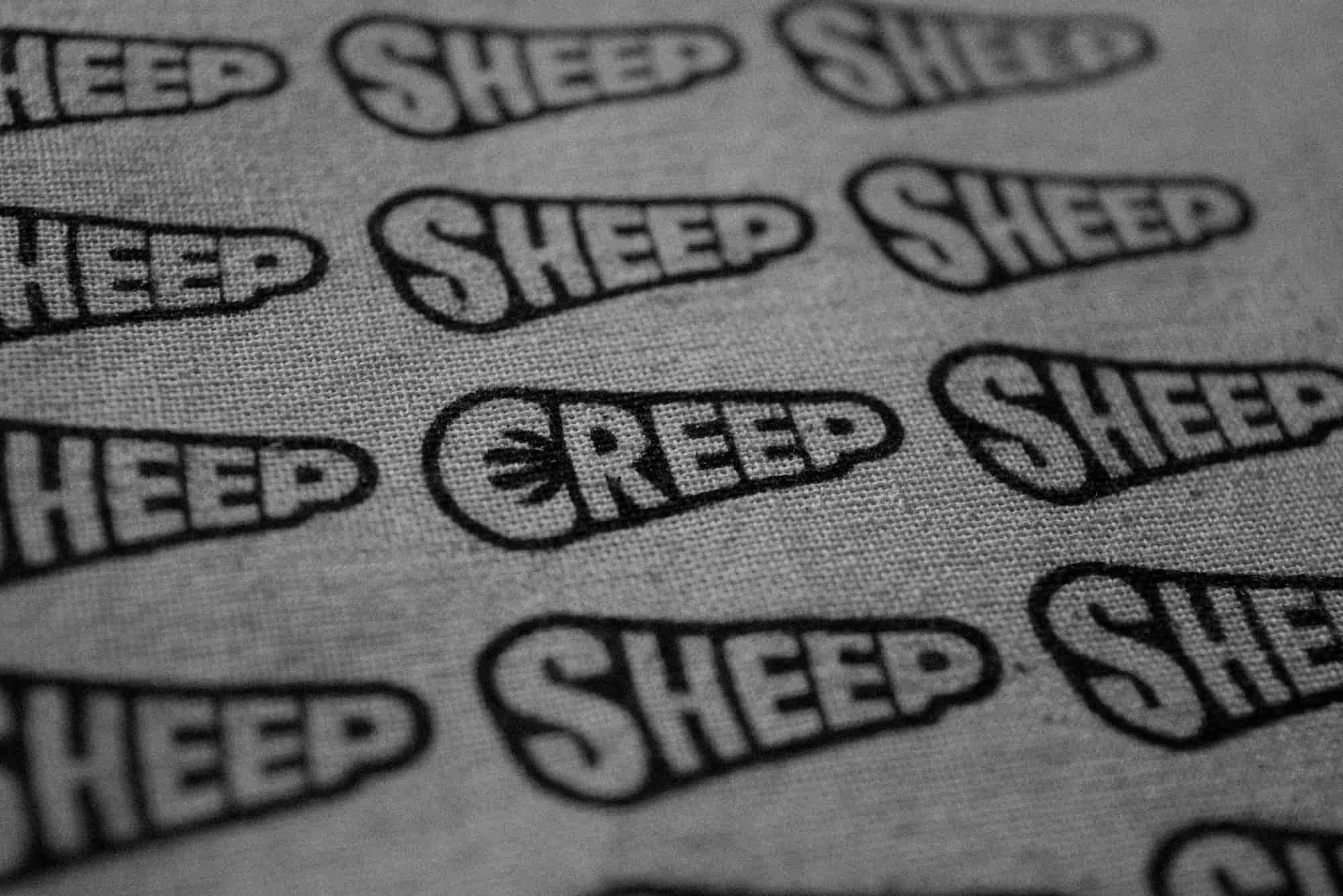 creep sheep concept on totebag in black & white, close up photograph.