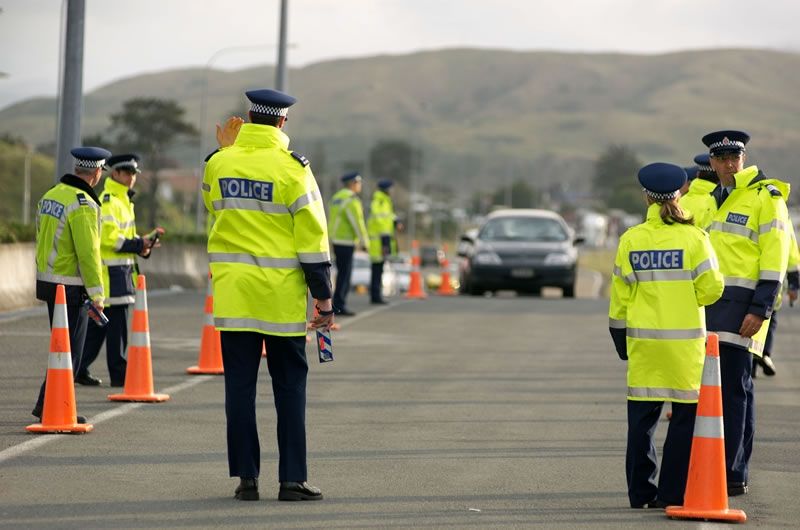 a group of people standing in a parking lot