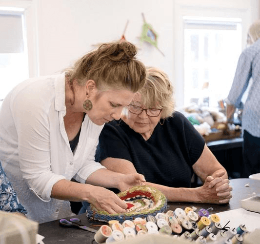 Shelburne Craft School instructors Bradie Hansen and Luba Routsong work on a project as part of “Weaving Your Story,” a collaboration with Age Well.