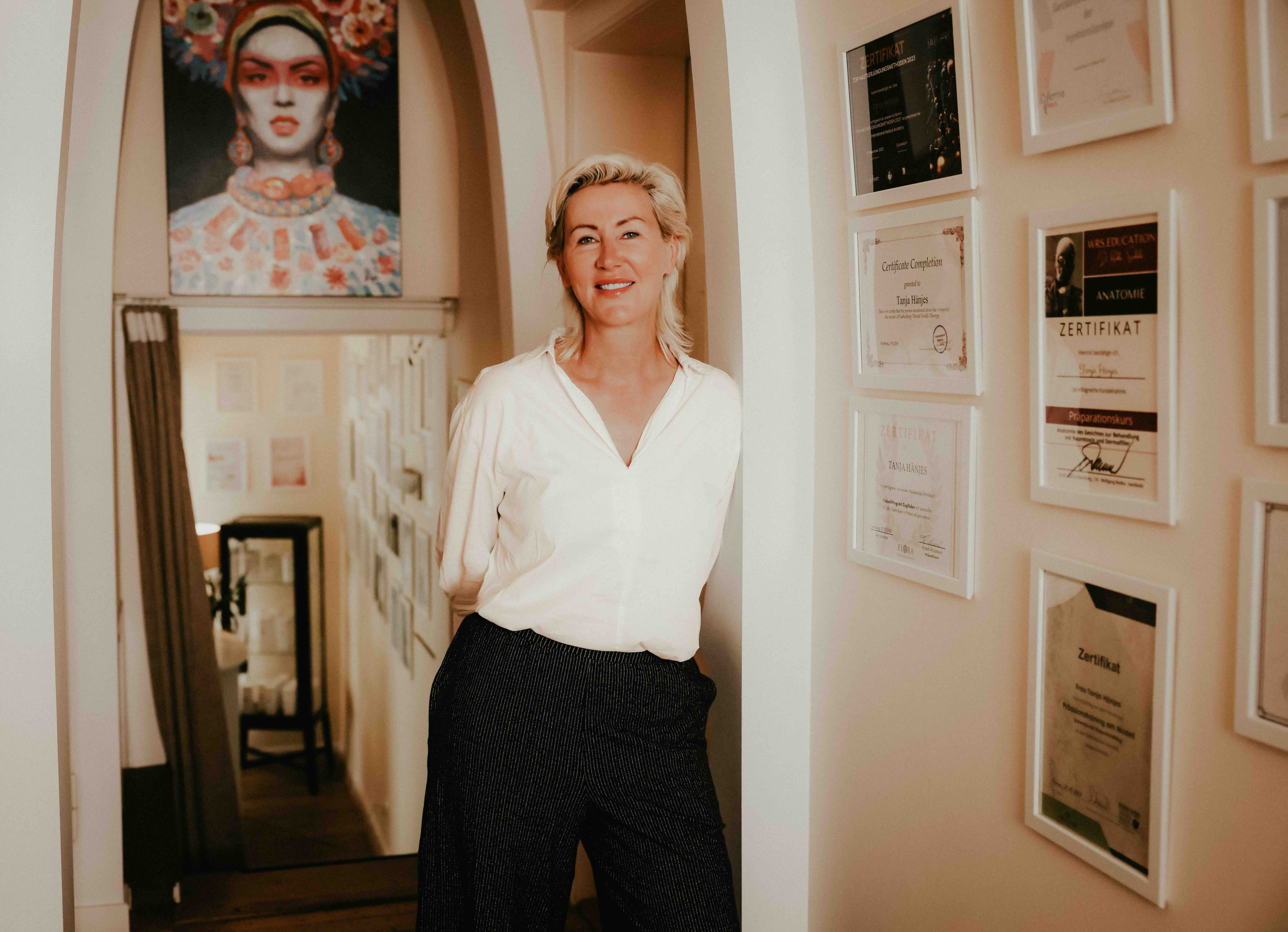 A woman lying down on a soft surface with her eyes closed, bathed in warm sunlight filtering through leaves. Her face has a natural glow, reflecting relaxation and tranquility in a serene spa-like setting.