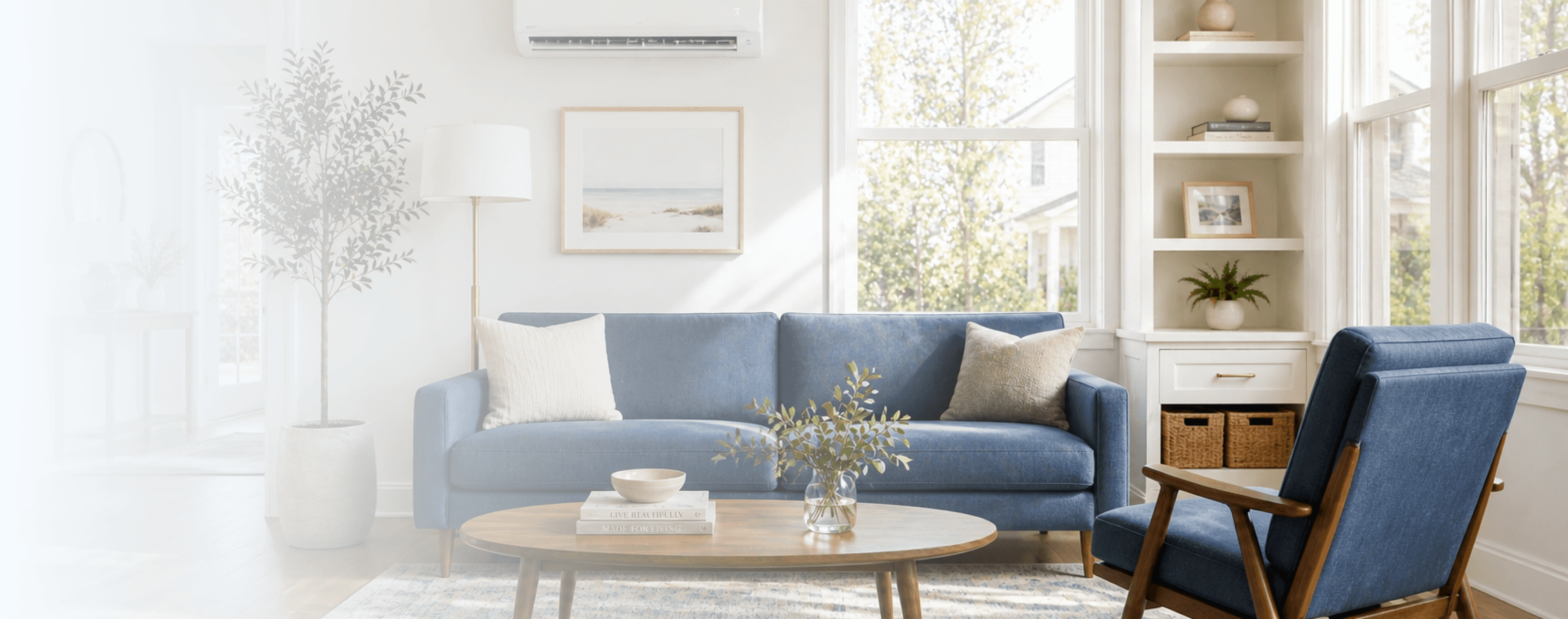 Bright modern living room with a blue sofa, wooden coffee table, plants, built-in shelves, and a large sunlit window.