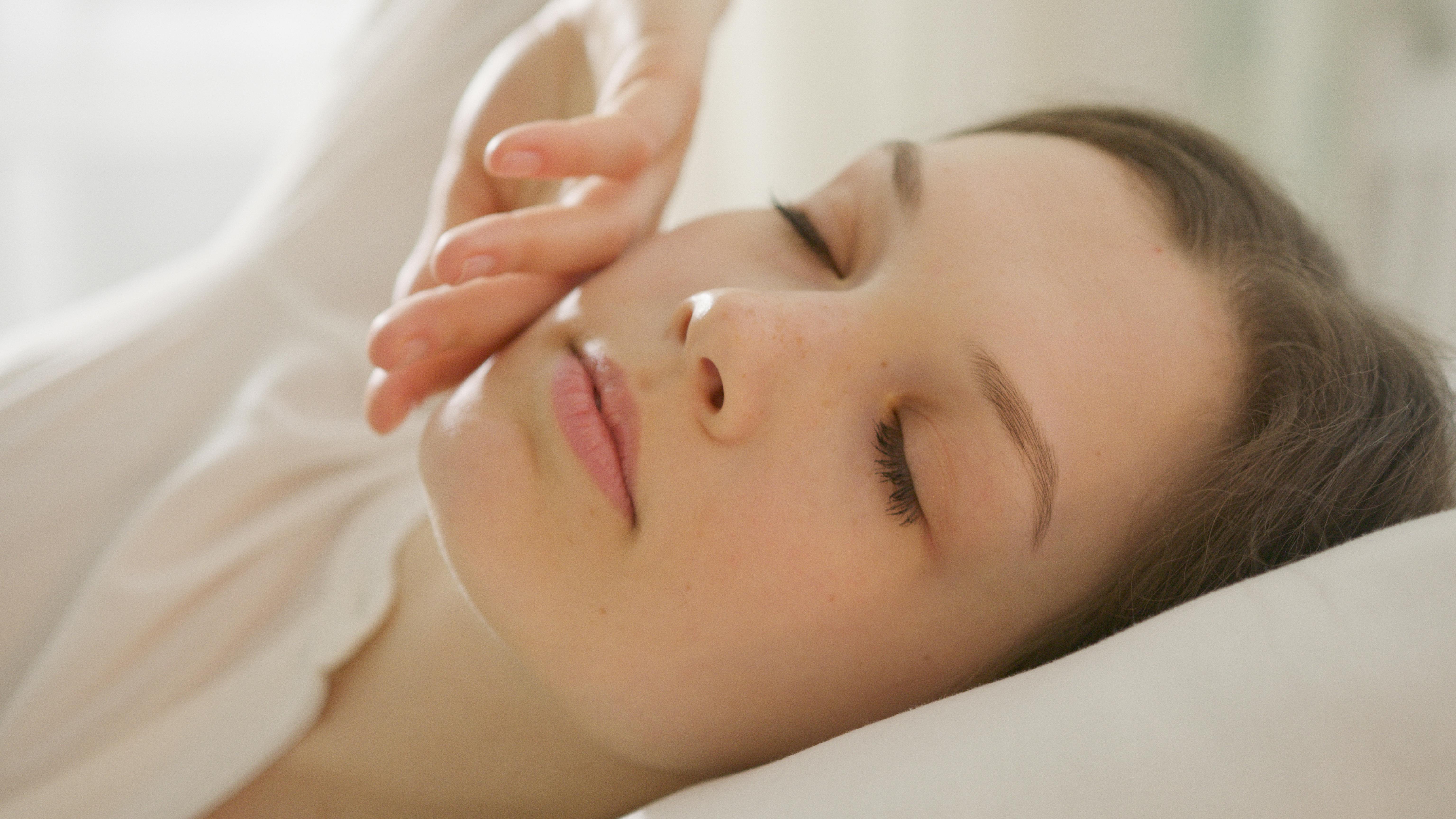 Woman resting peacefully following sleep apnea therapy