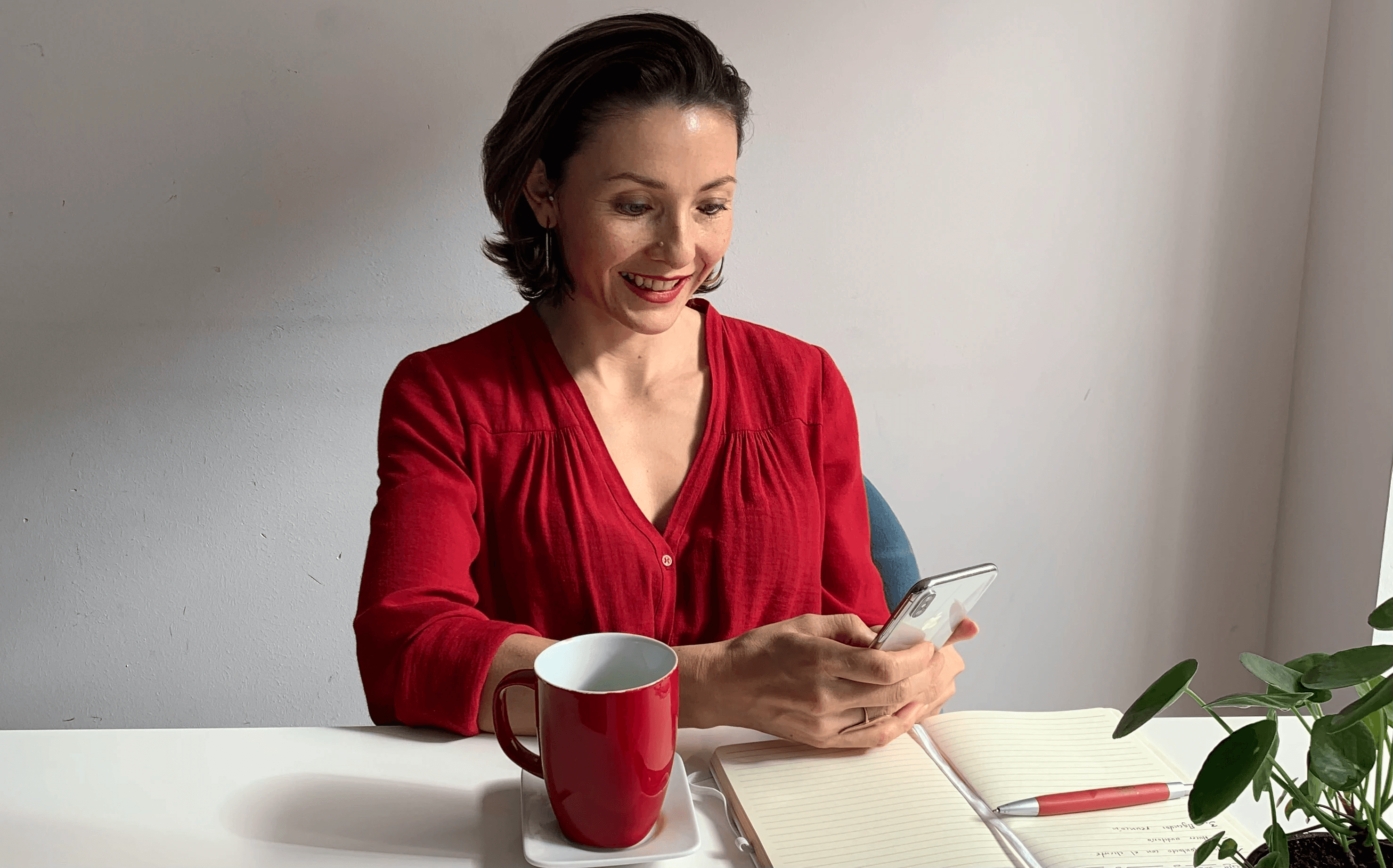 Man in profile against a red draped background with dramatic lighting.