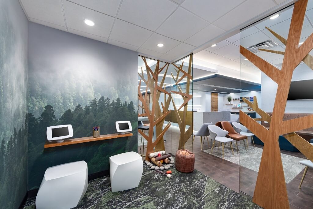 A modern interior with a nature-themed window treatment, wooden shelves, and minimalist seating.