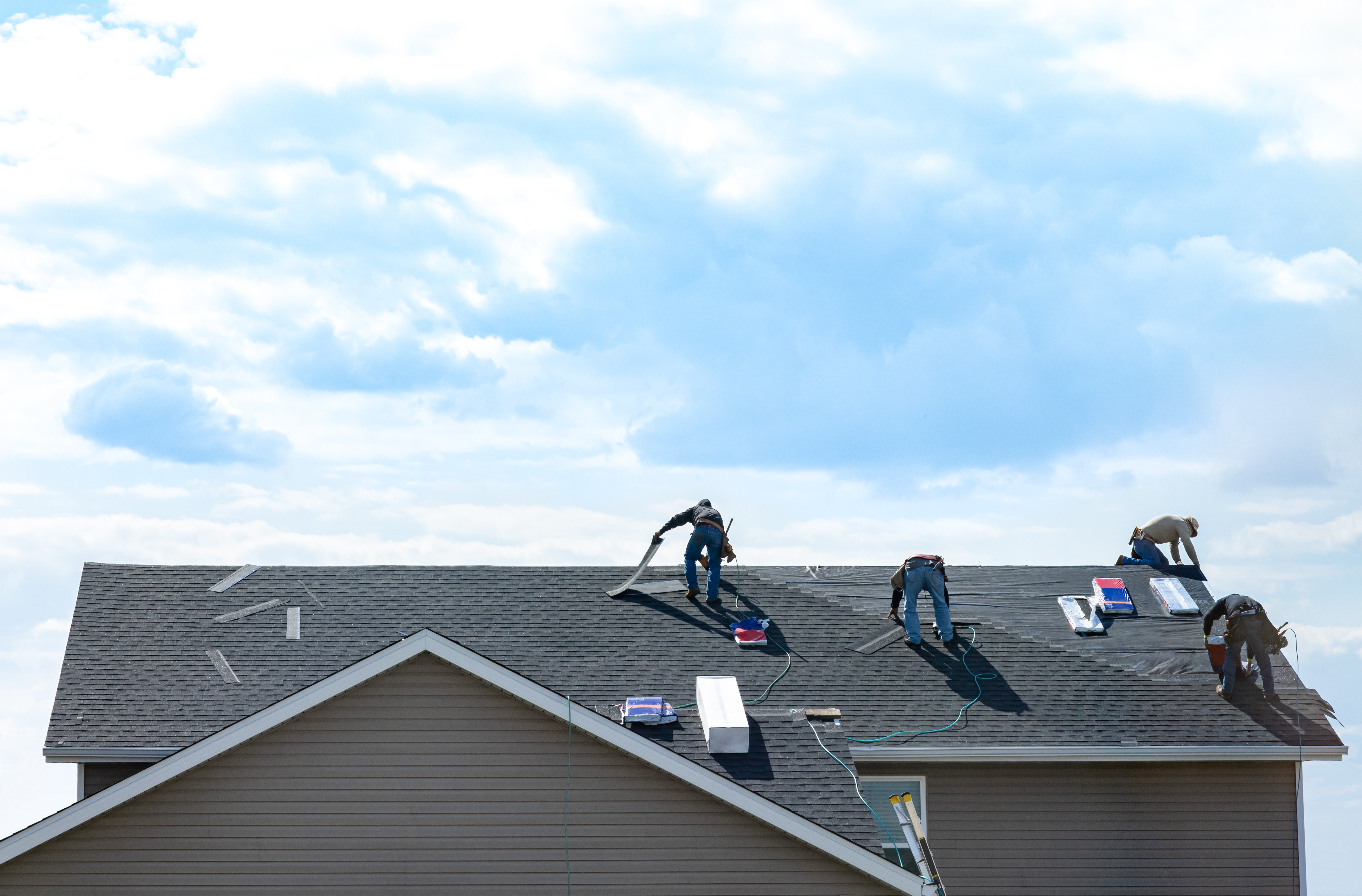 St. Louis roofing contractors performing roof installation with professional tools and safety gearRetry